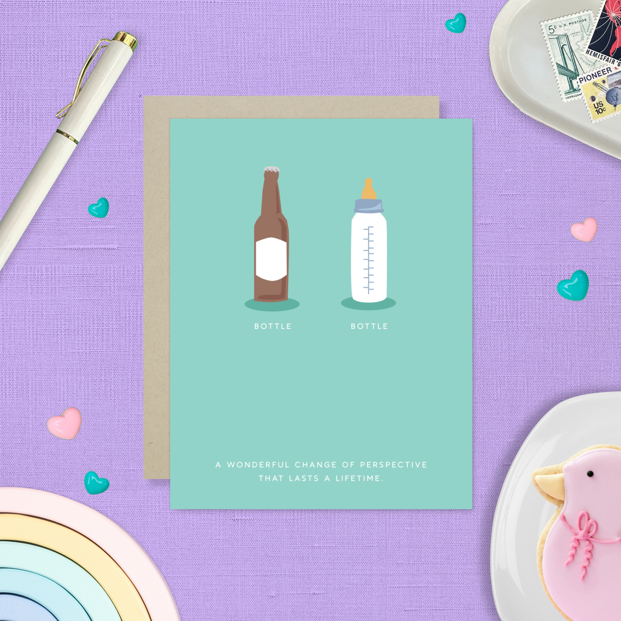 Baby greeting card with beer and baby bottle and 'a wonderful change of perspective that lasts a lifetime' text
