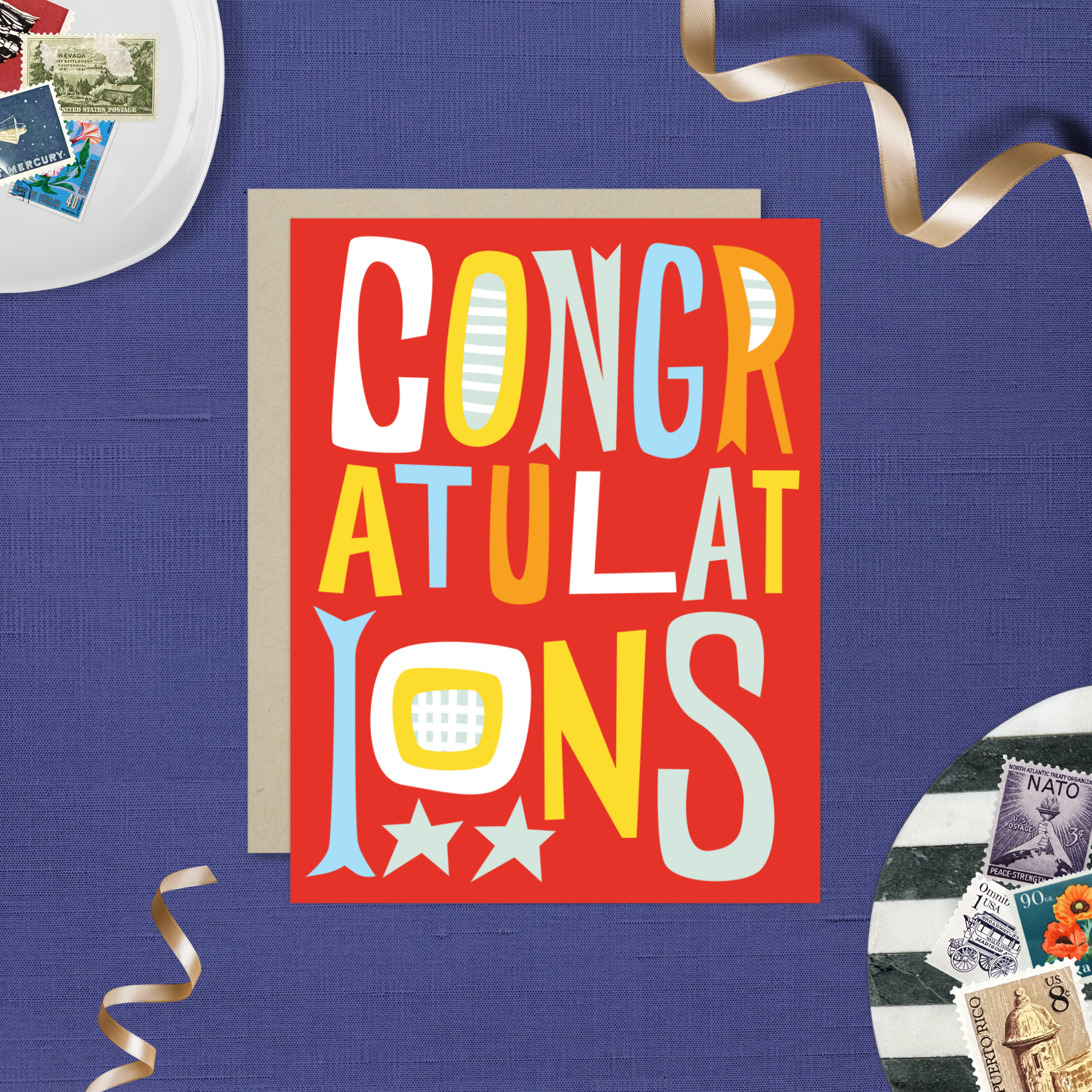 A colorful congratulations greeting card with the word 'CONGRATULATIONS' written in bold, playful lettering, predominantly in red, with additional decorative elements like stars.