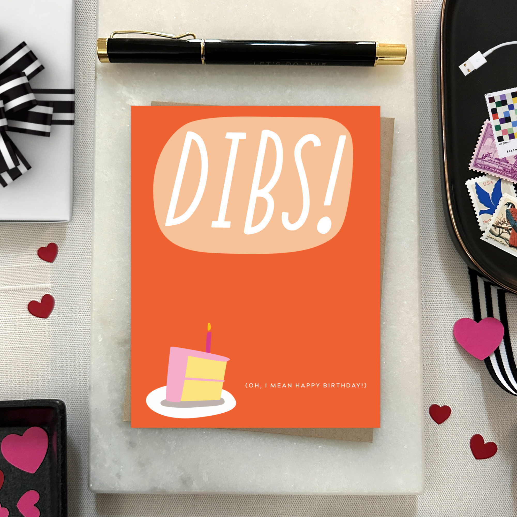 Card with 'DIBS! (Oh, I mean happy birthday! )' text and a cake illustration on an orange background.