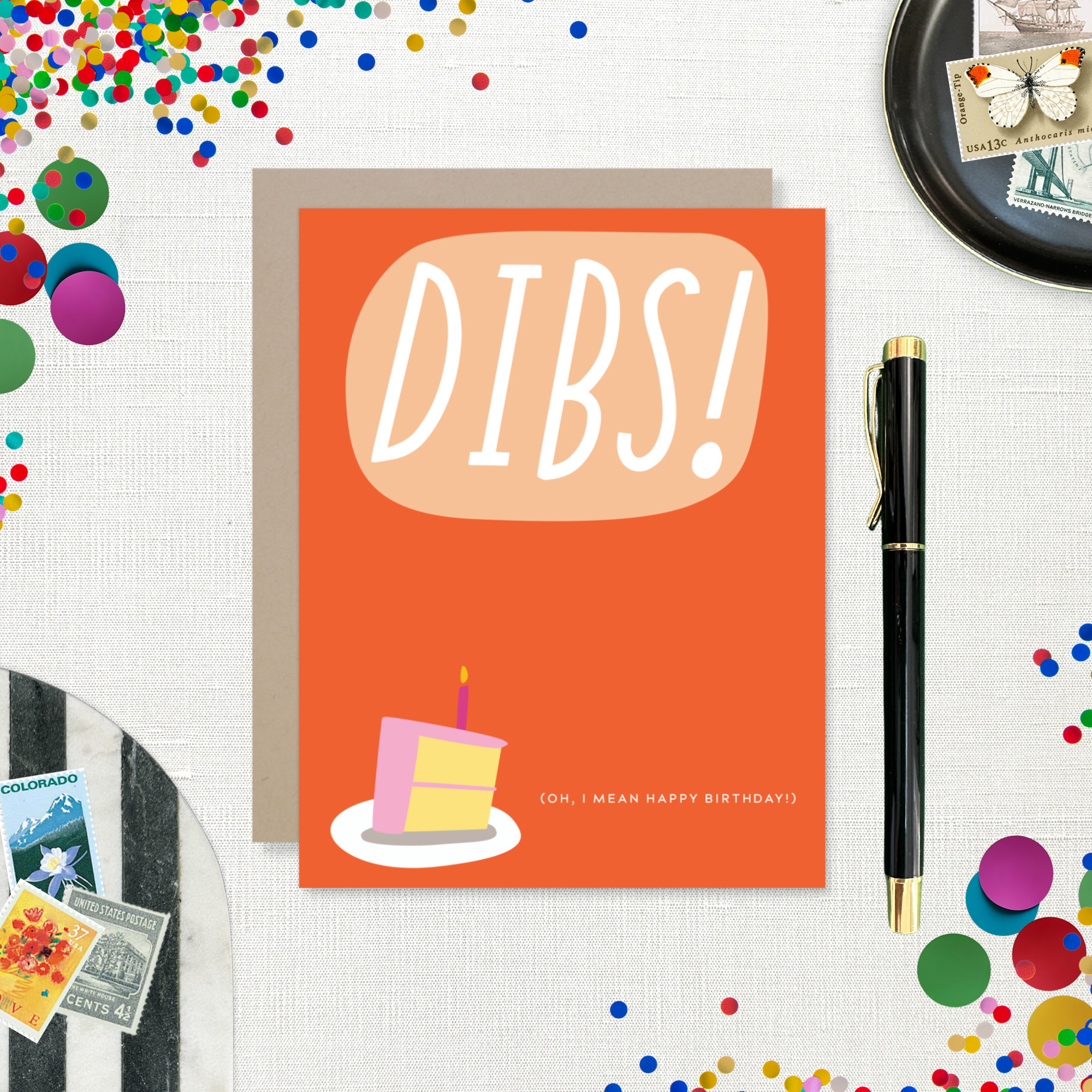 Card with 'DIBS! (Oh, I mean happy birthday! )' text and a cake illustration on an orange background.