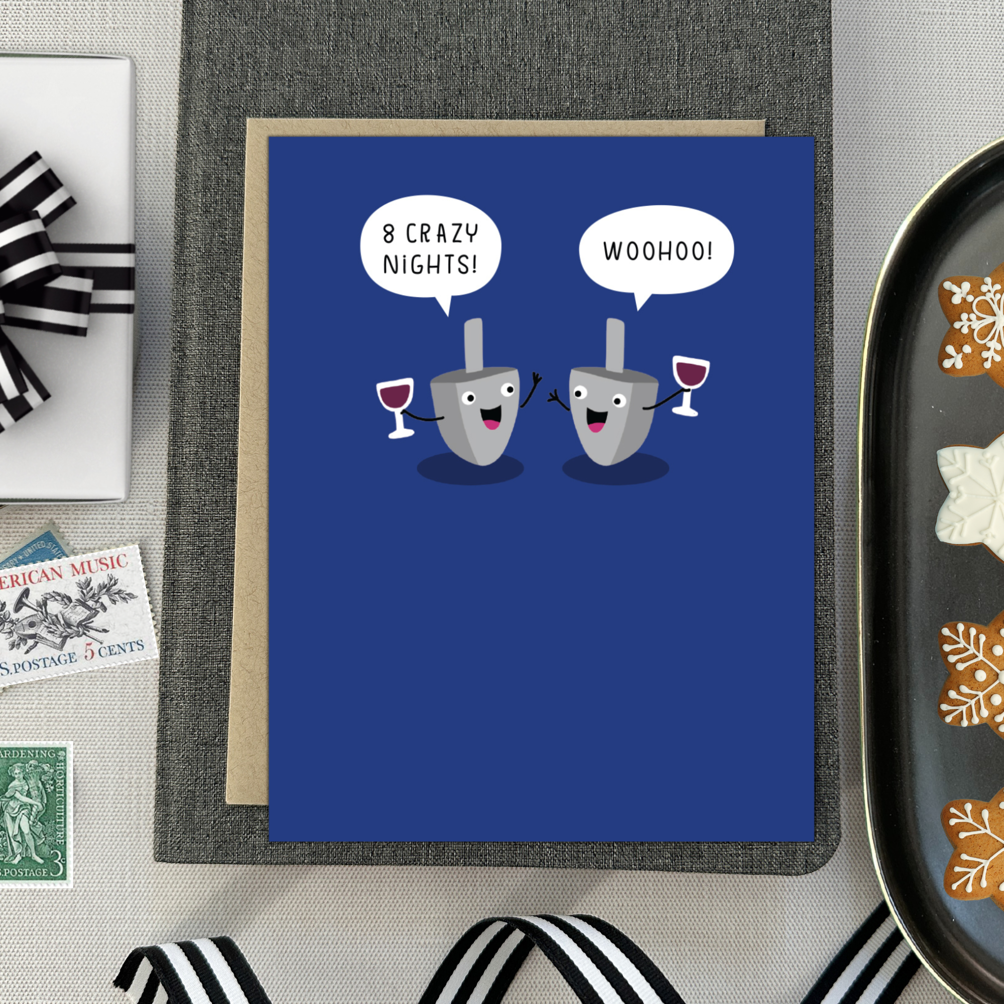 Hannukah greeting card with 2 dreidels drinking. One is saying '8 crazy nights' the other says 'woohoo!'