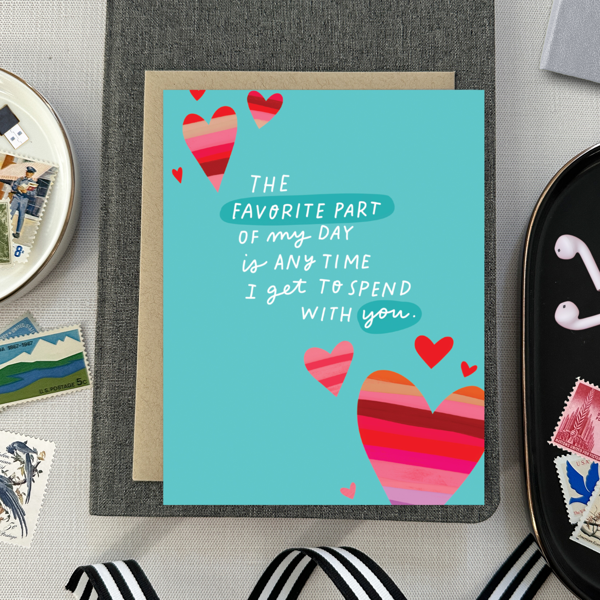 A wedding/anniversary greeting card with hand-lettered text expressing love, surrounded by heart designs.