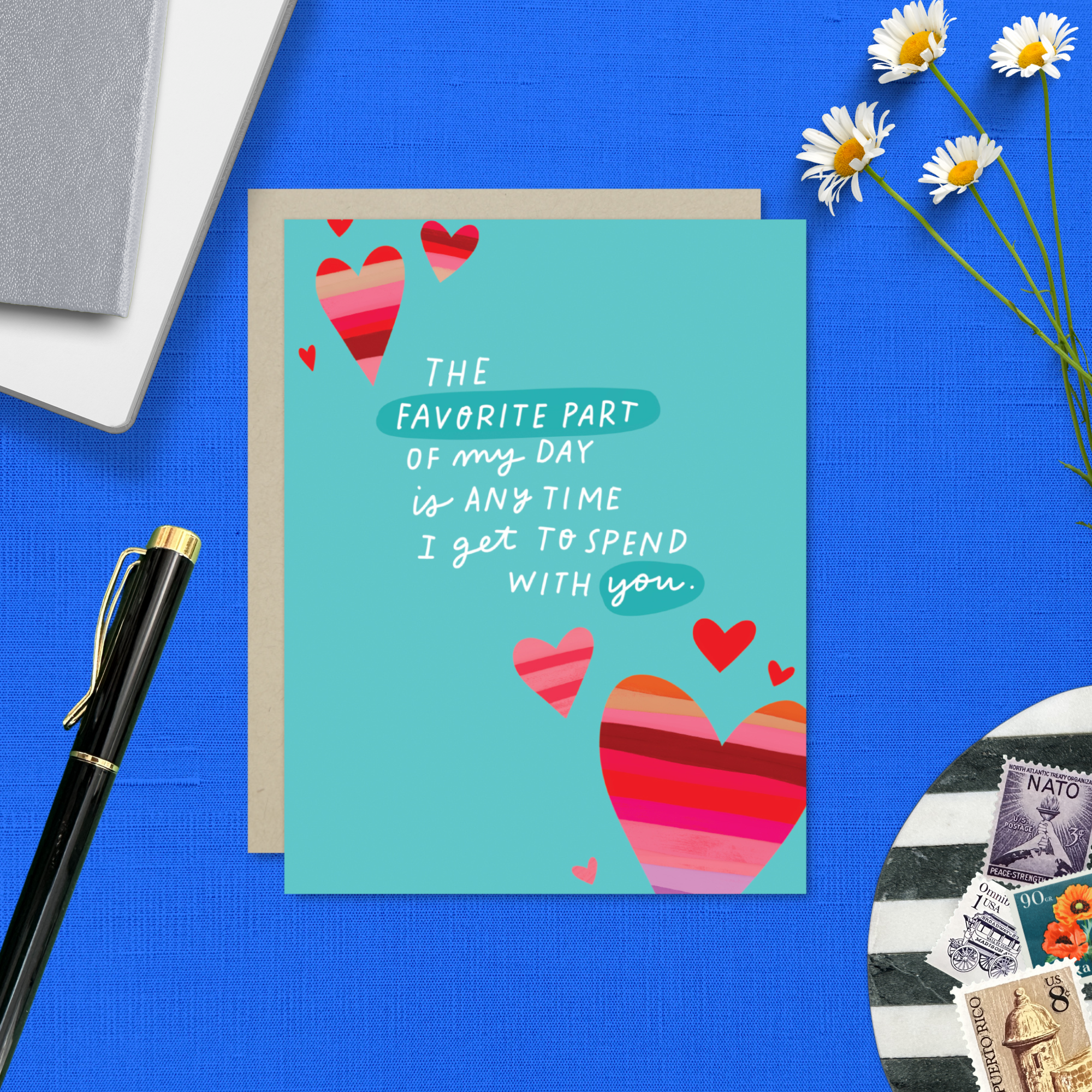 A wedding/anniversary greeting card with hand-lettered text expressing love, surrounded by heart designs.