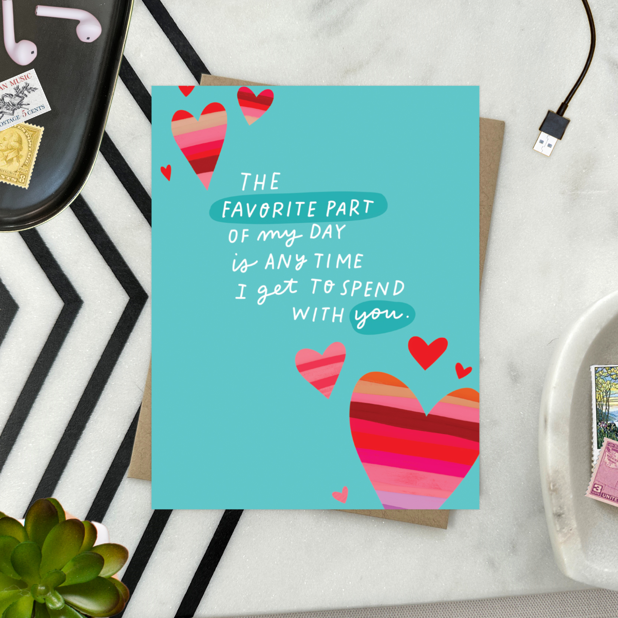 A wedding/anniversary greeting card with hand-lettered text expressing love, surrounded by heart designs.