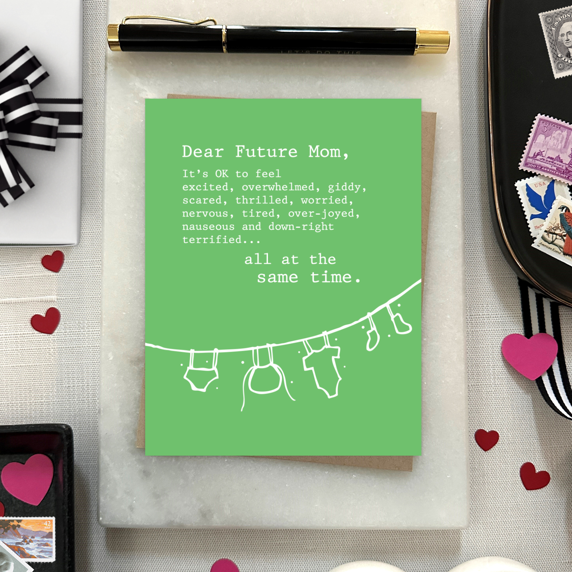 Baby greeting card with clothes hanging and 'dear future mom...' text
