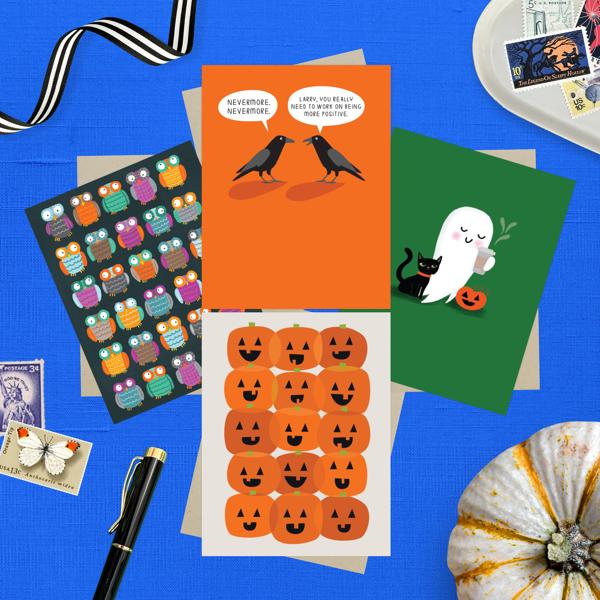 Collection of Halloween-themed cards featuring an adorable ghost with black cat and coffee, one with 2 funny ravens saying "Nevermore," one with a jack-o-lantern pattern, and one with an owl pattern and stamps on a blue background.