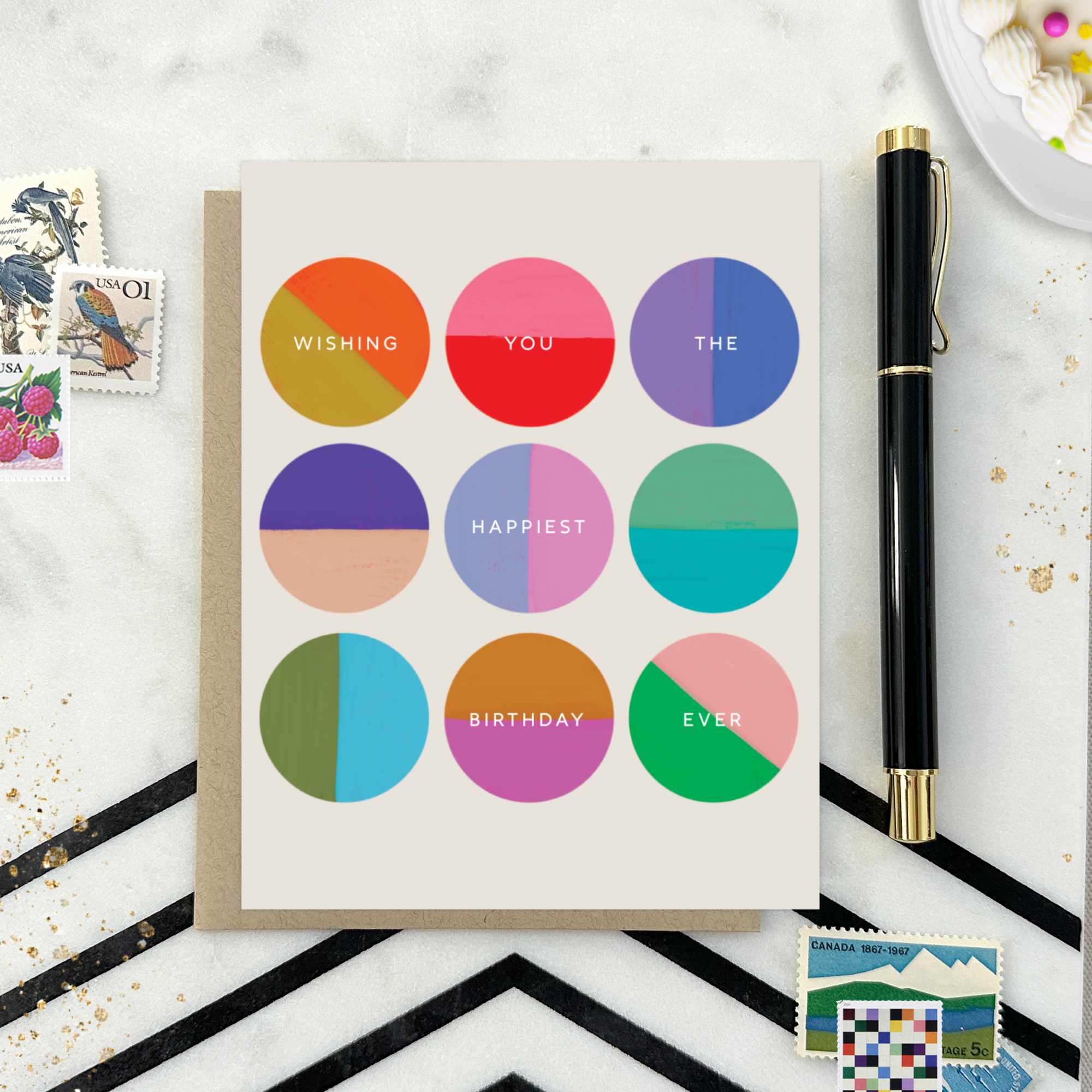 A colorful birthday greeting card with multiple circles in different shades, each containing a wish for the recipient's happiest birthday ever