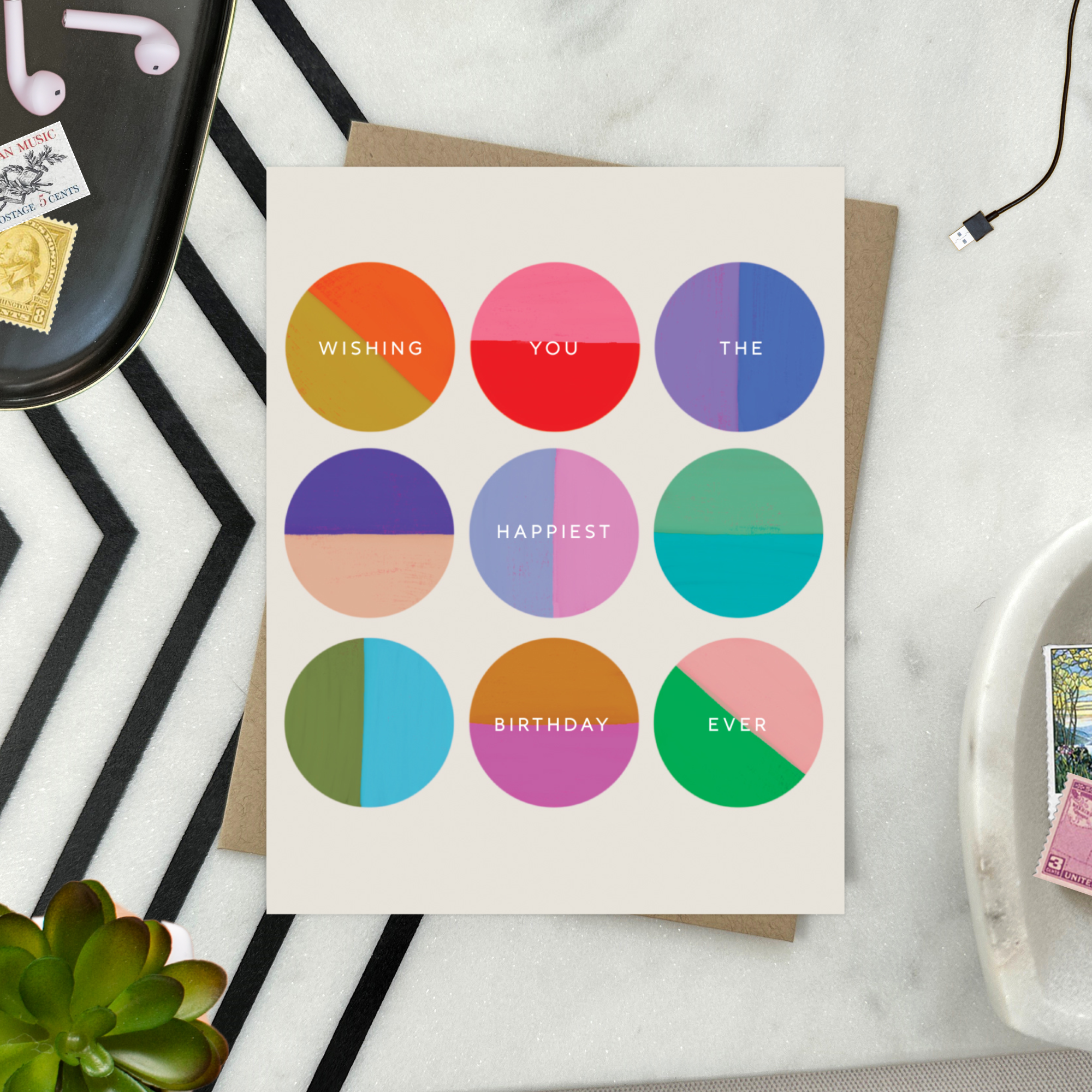 A colorful birthday greeting card with multiple circles in different shades, each containing a wish for the recipient's happiest birthday ever