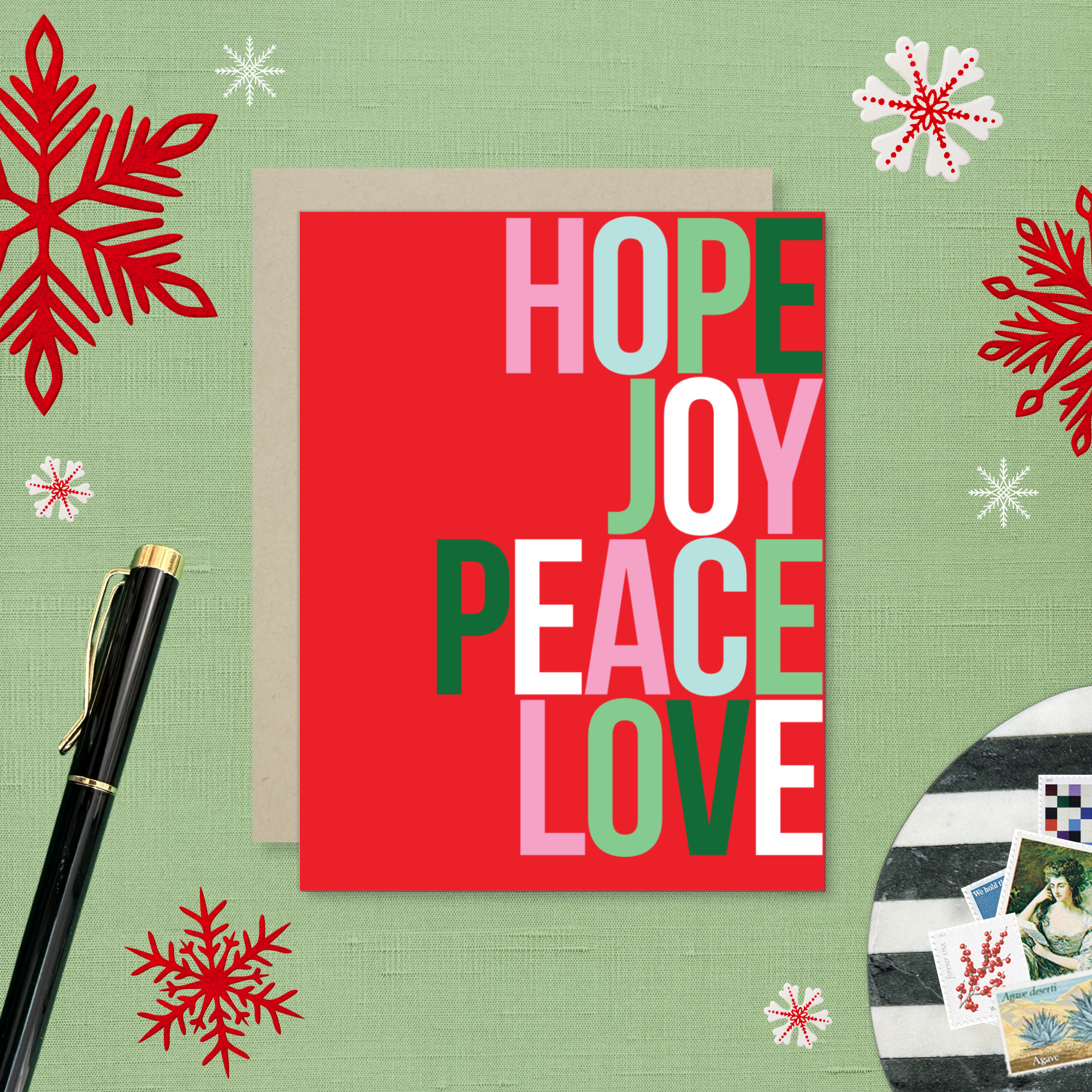 A red holiday greeting card with the words 'HOPE, JOY, PEACE, LOVE' stacked in a graphic design.