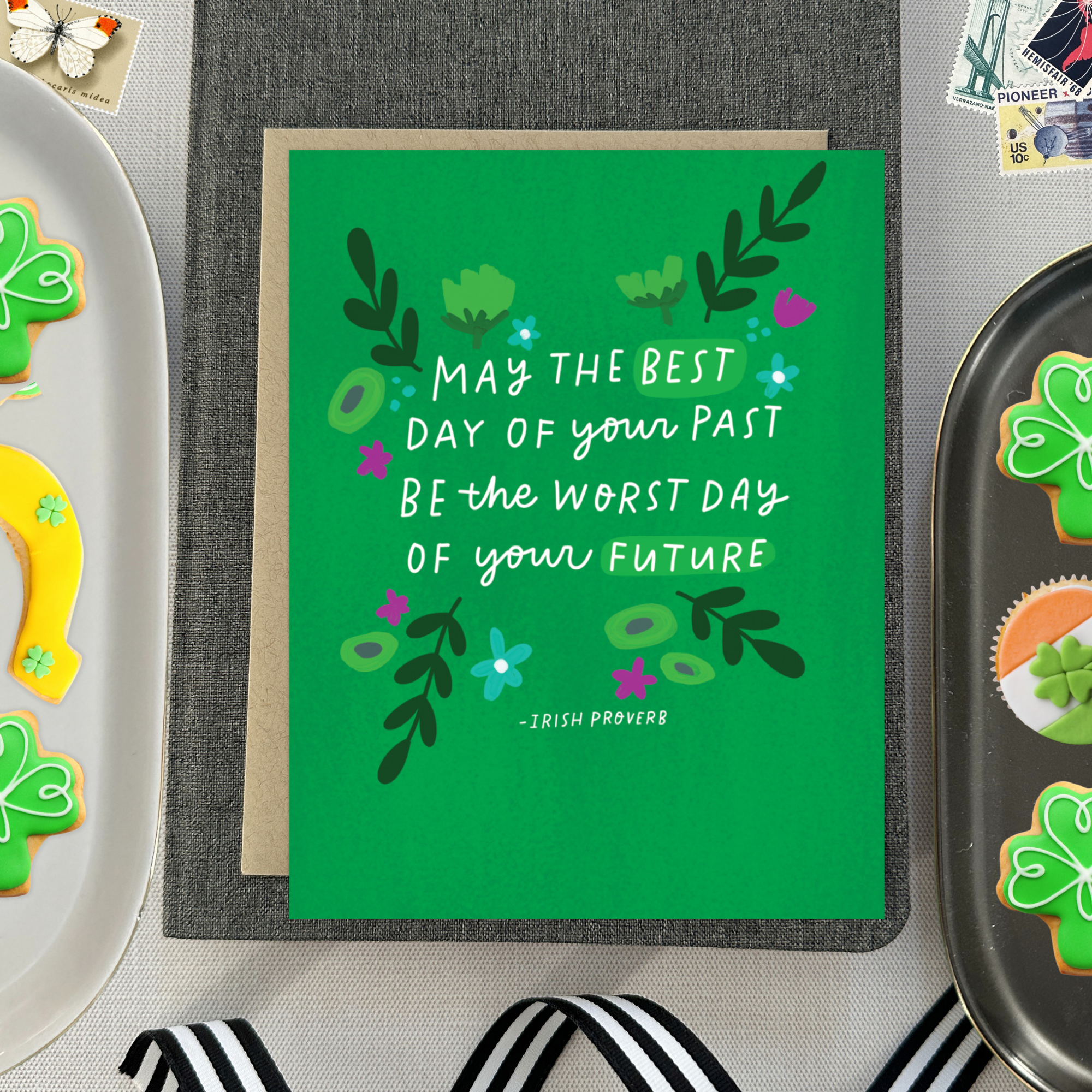 A St. Patricks day greeting card with floral patterns and a hand-lettered Irish proverb.