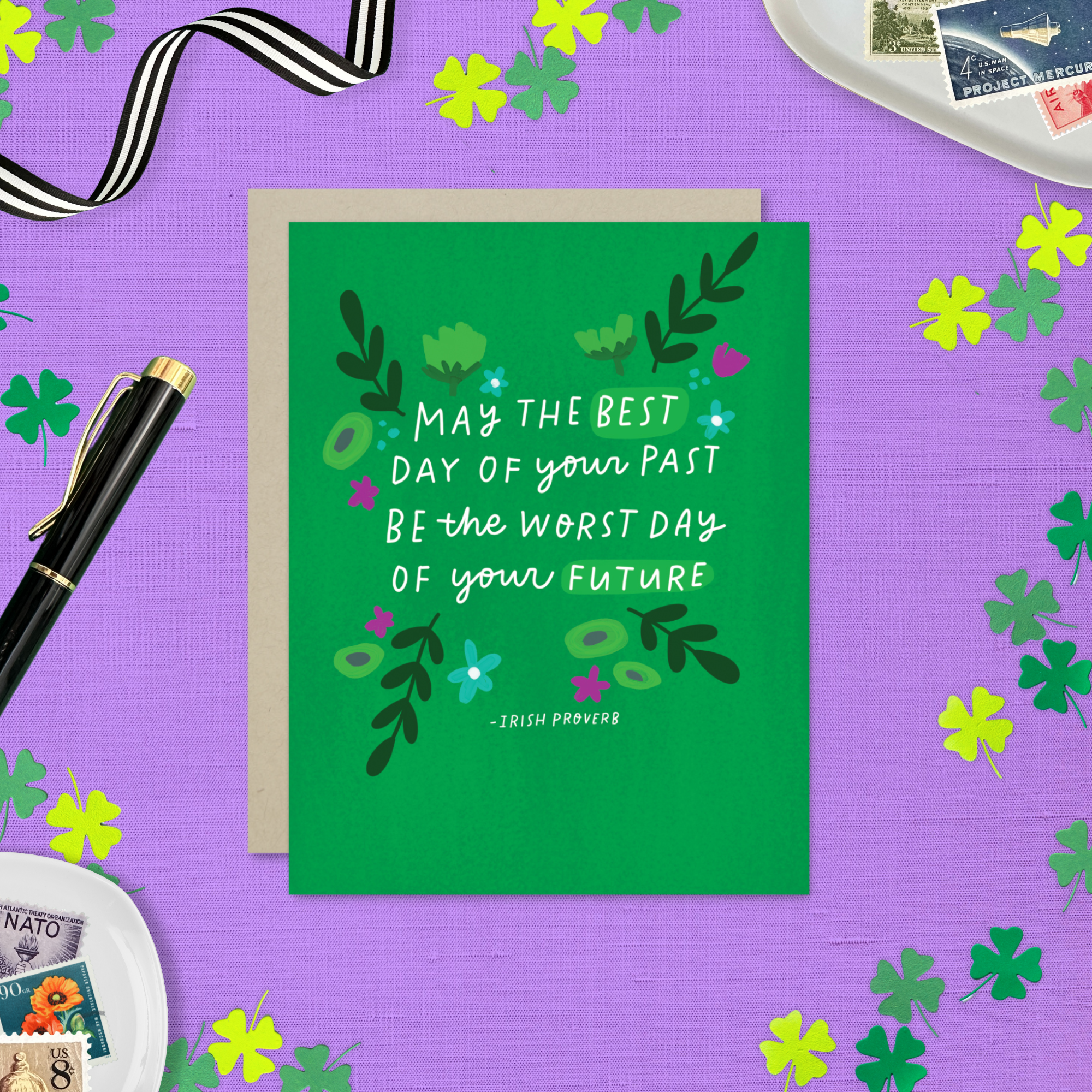 A St. Patricks day greeting card with floral patterns and a hand-lettered Irish proverb.