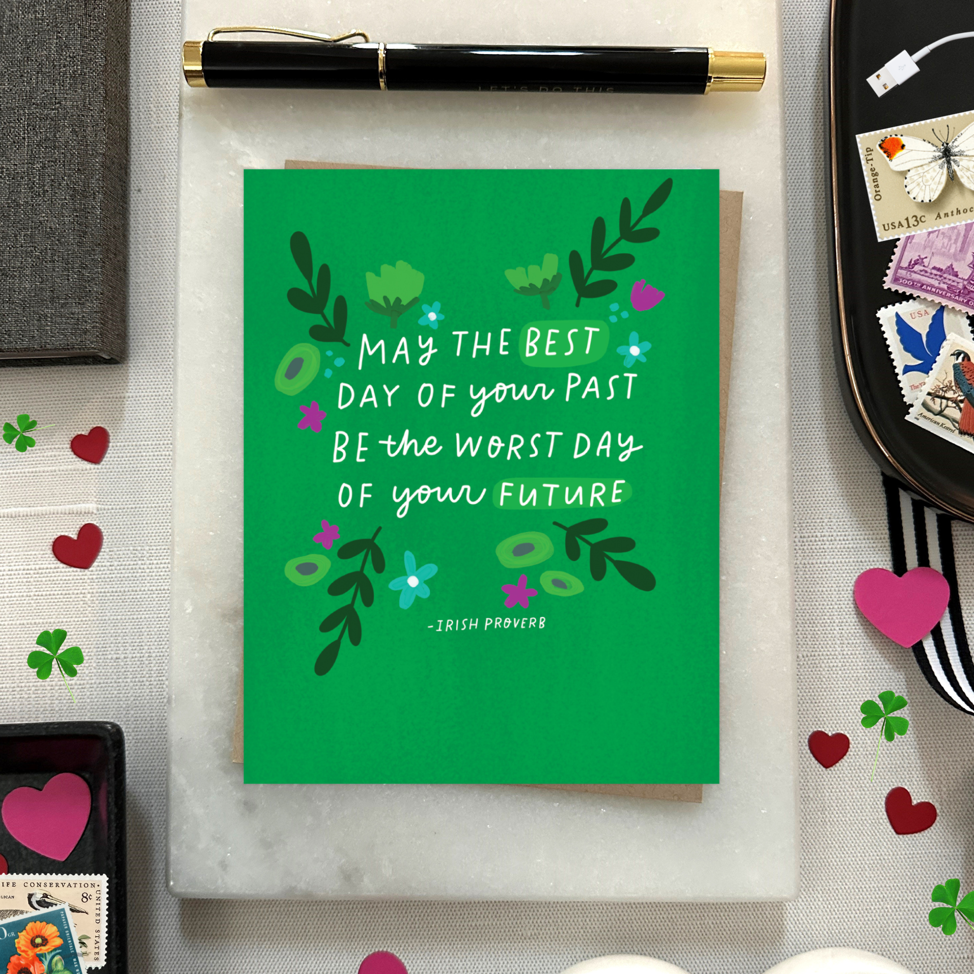 A St. Patricks day greeting card with floral patterns and a hand-lettered Irish proverb.