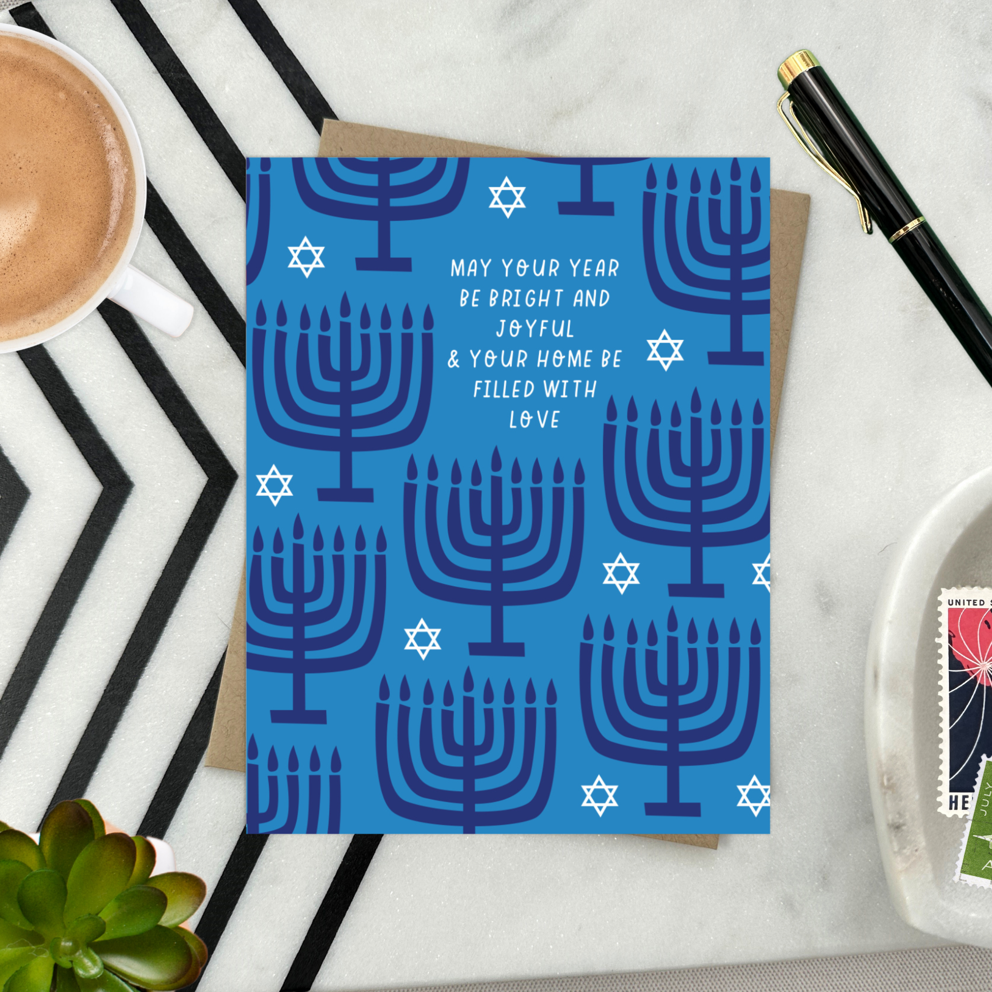 Hannukah greeting card with menorahs and stars of David scattered with 'may your year be bright and joyful & your home be filled with love' text