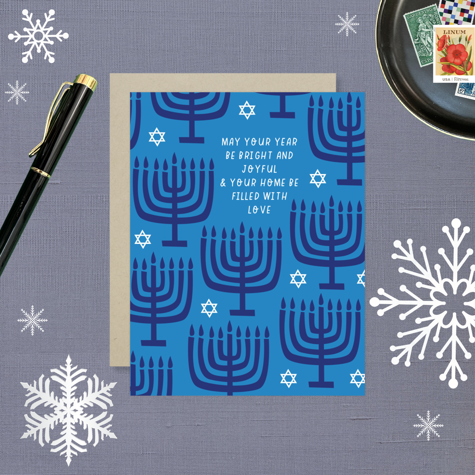 Hannukah greeting card with menorahs and stars of David scattered with 'may your year be bright and joyful & your home be filled with love' text