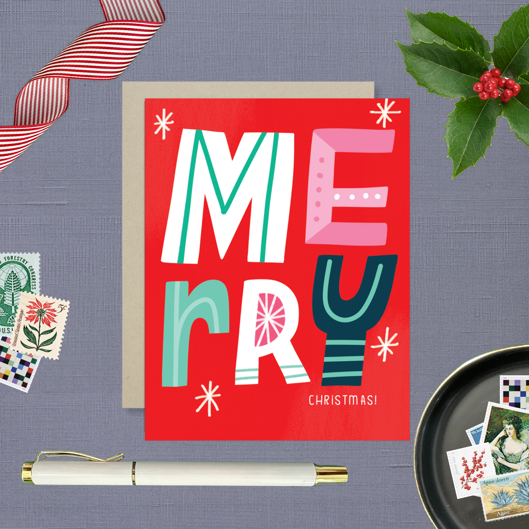 A festive Christmas greeting card with the word 'Merry' written in colorful, decorative lettering on a red background, with 'Christmas' written below.