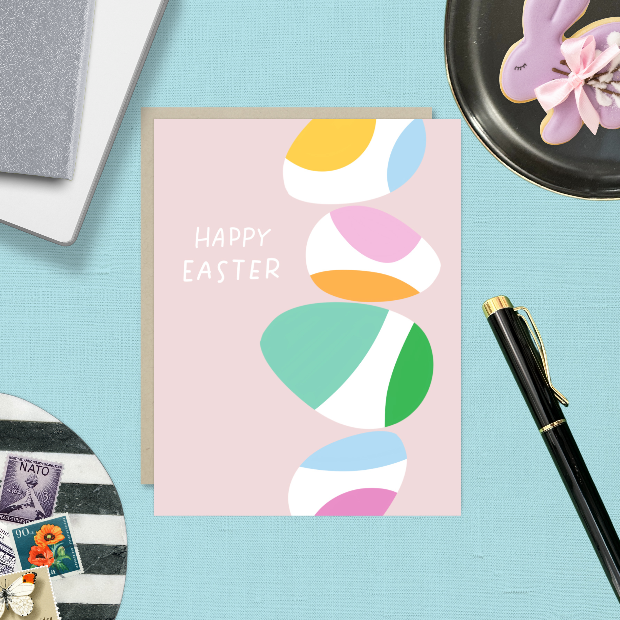 Easter greeting card with stack of eggs and 'happy easter' text
