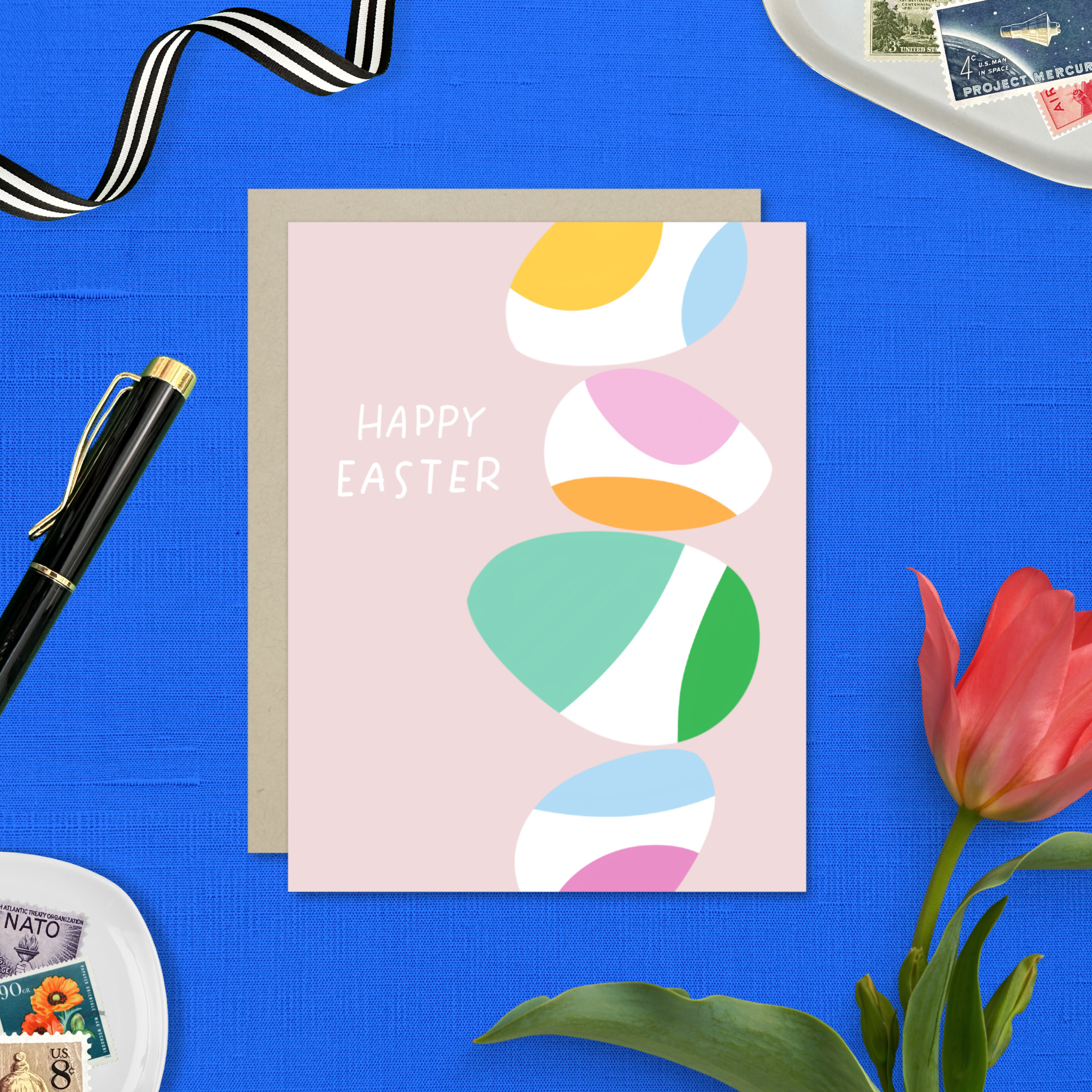 Easter greeting card with stack of eggs and 'happy easter' text