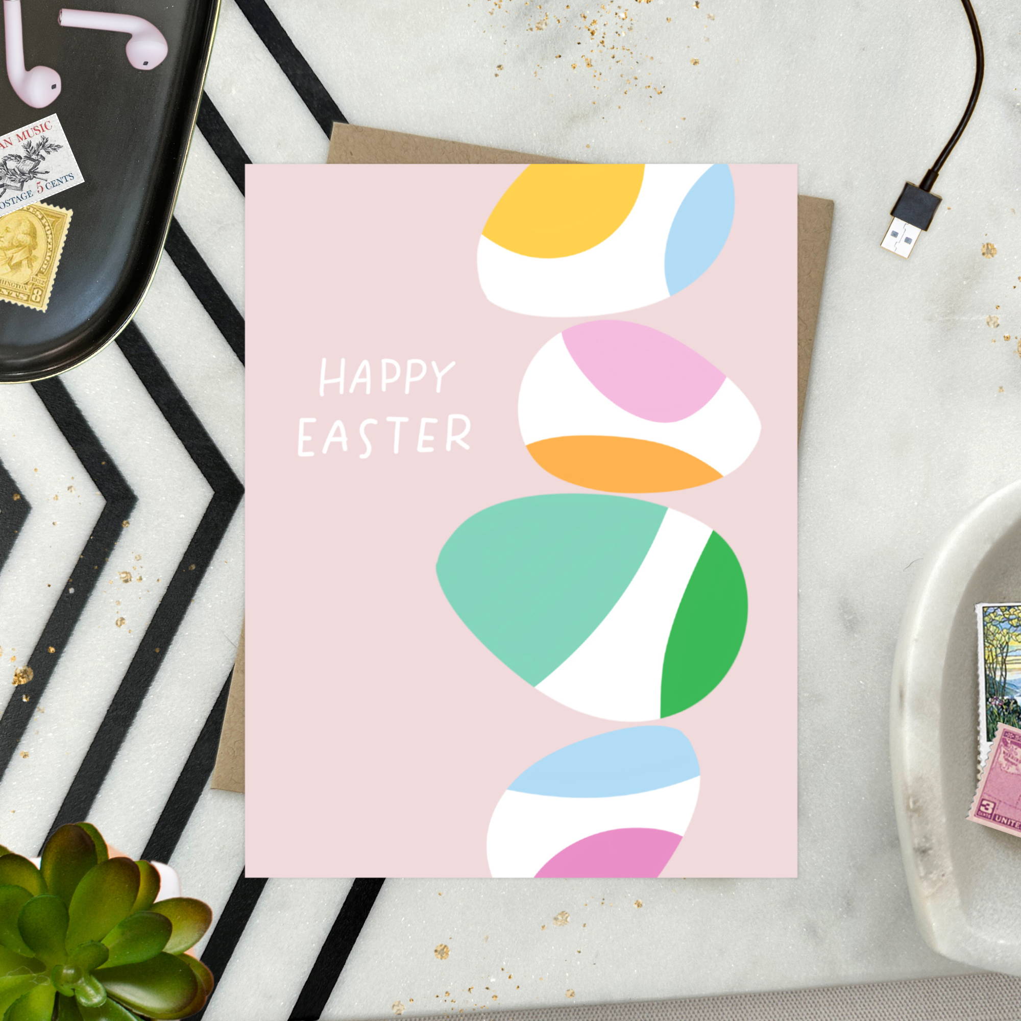 Easter greeting card with stack of eggs and 'happy easter' text