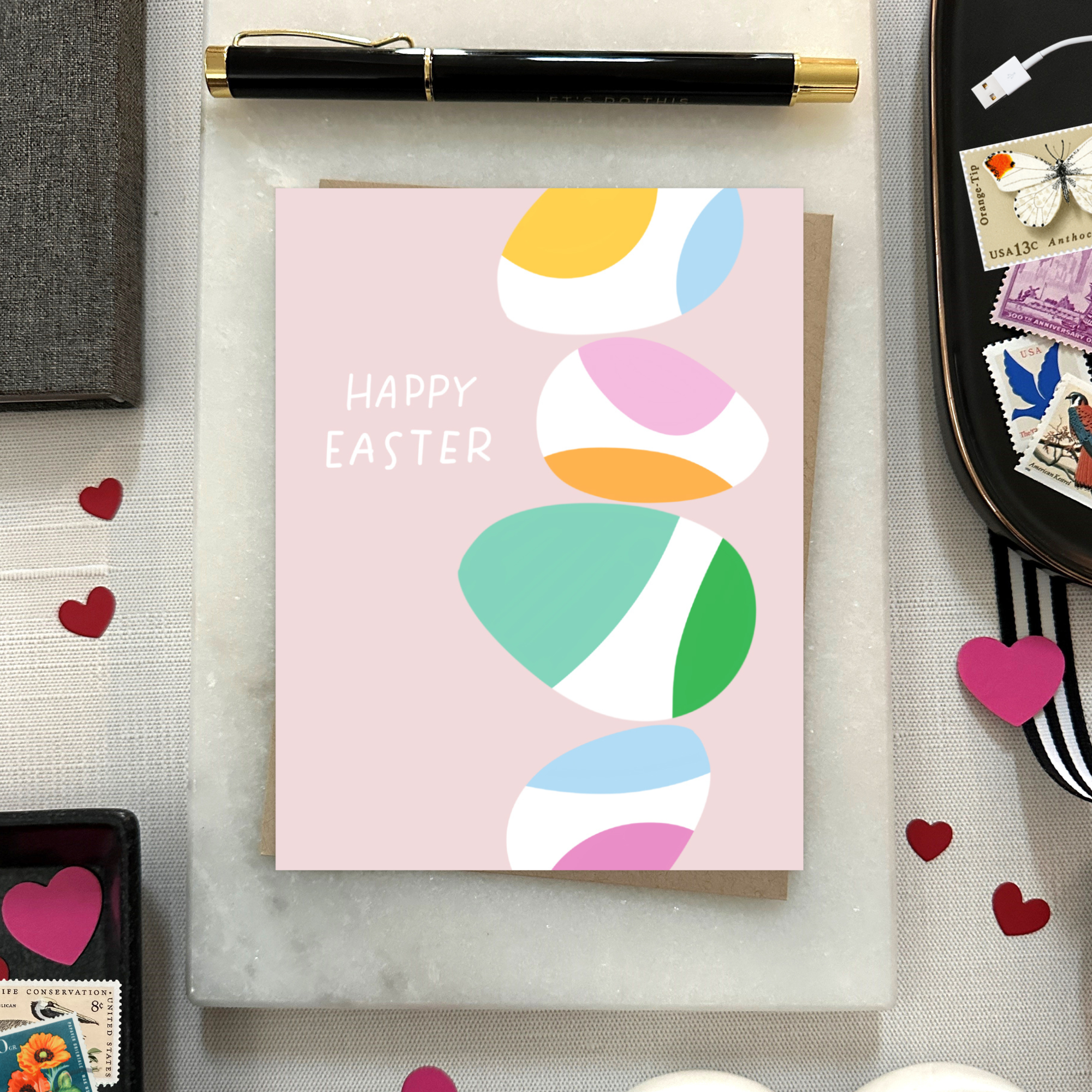 Easter greeting card with stack of eggs and 'happy easter' text