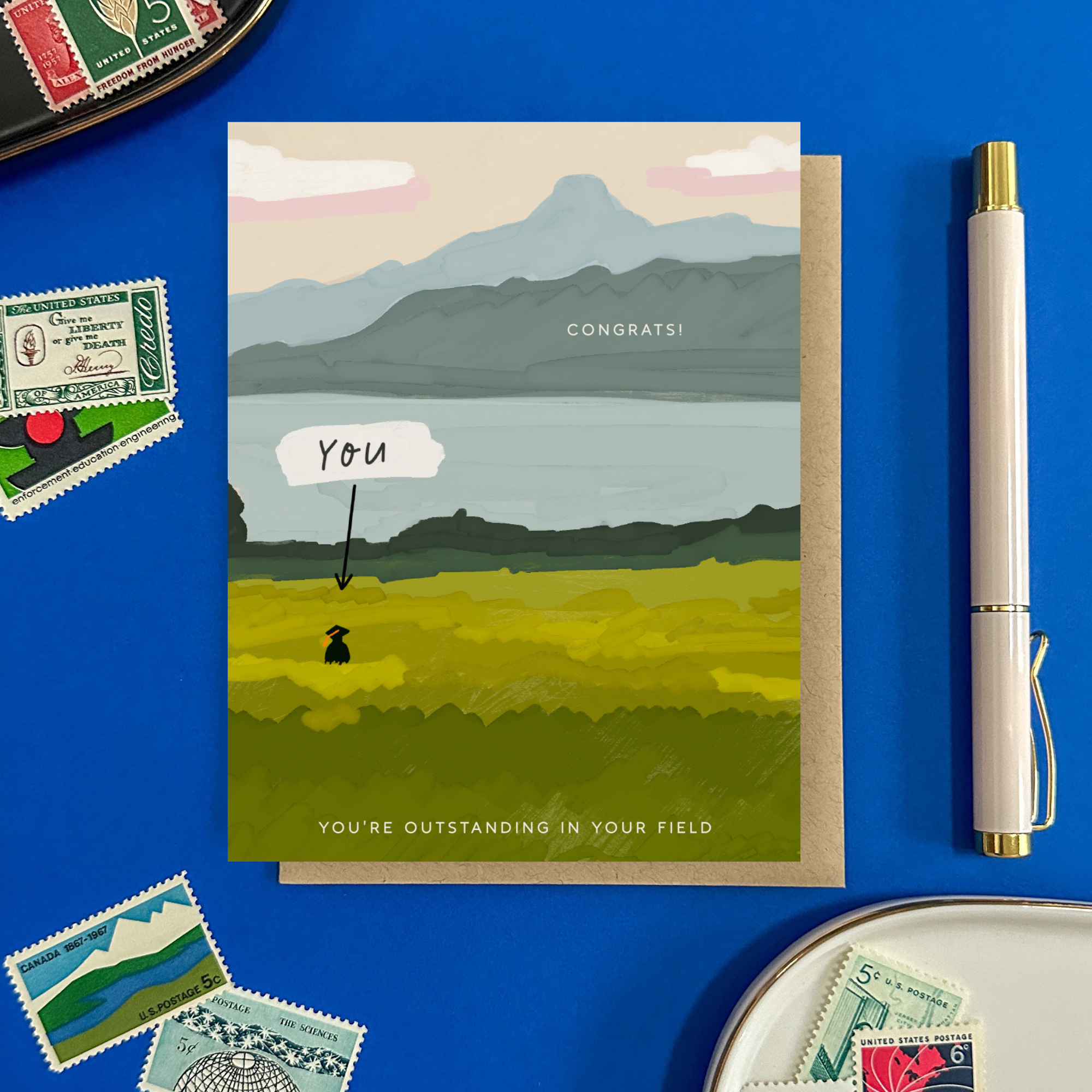 Graduation greeting card with person out standing in their field with a narrow pointing to them that says 'you'