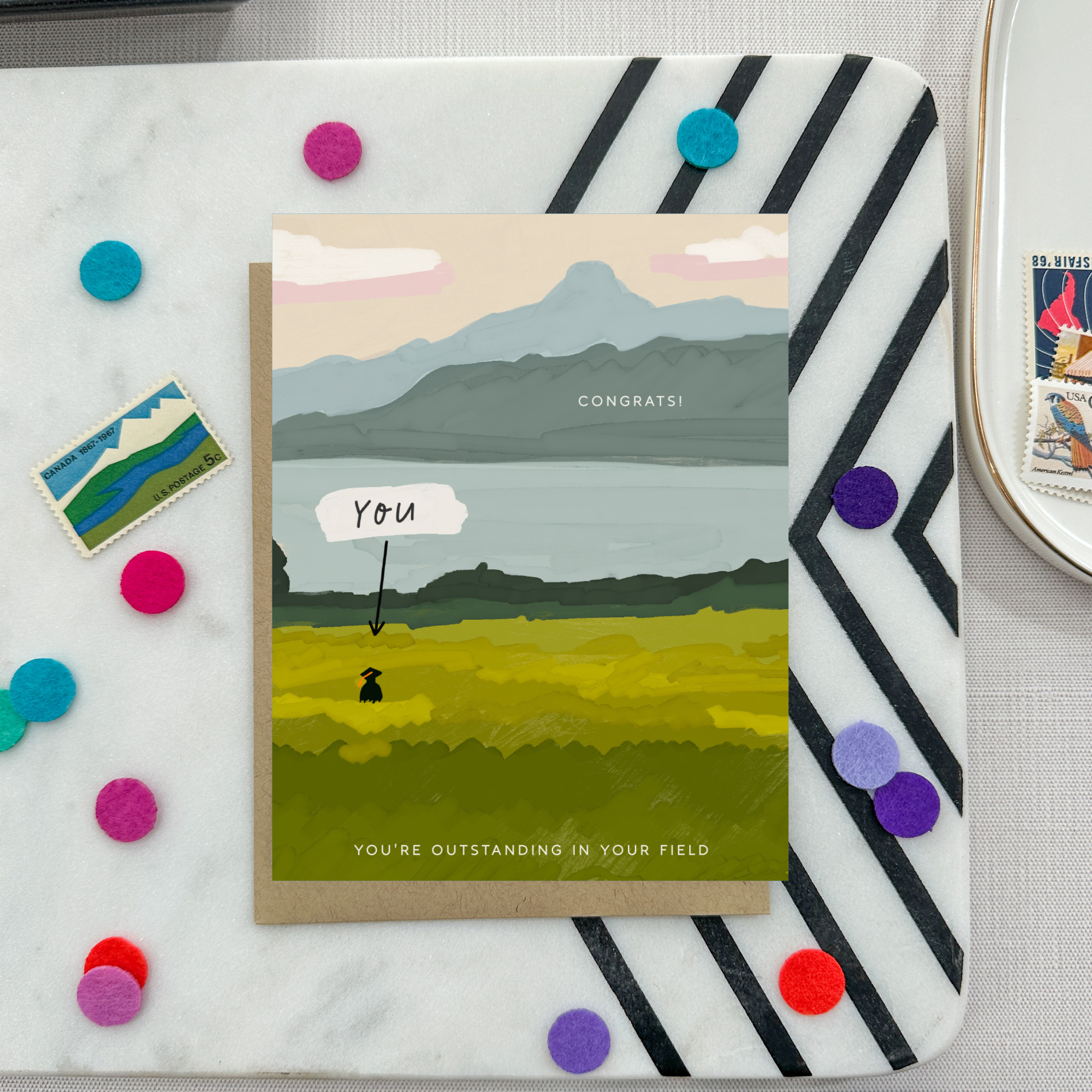 Graduation greeting card with person out standing in their field with a narrow pointing to them that says 'you'