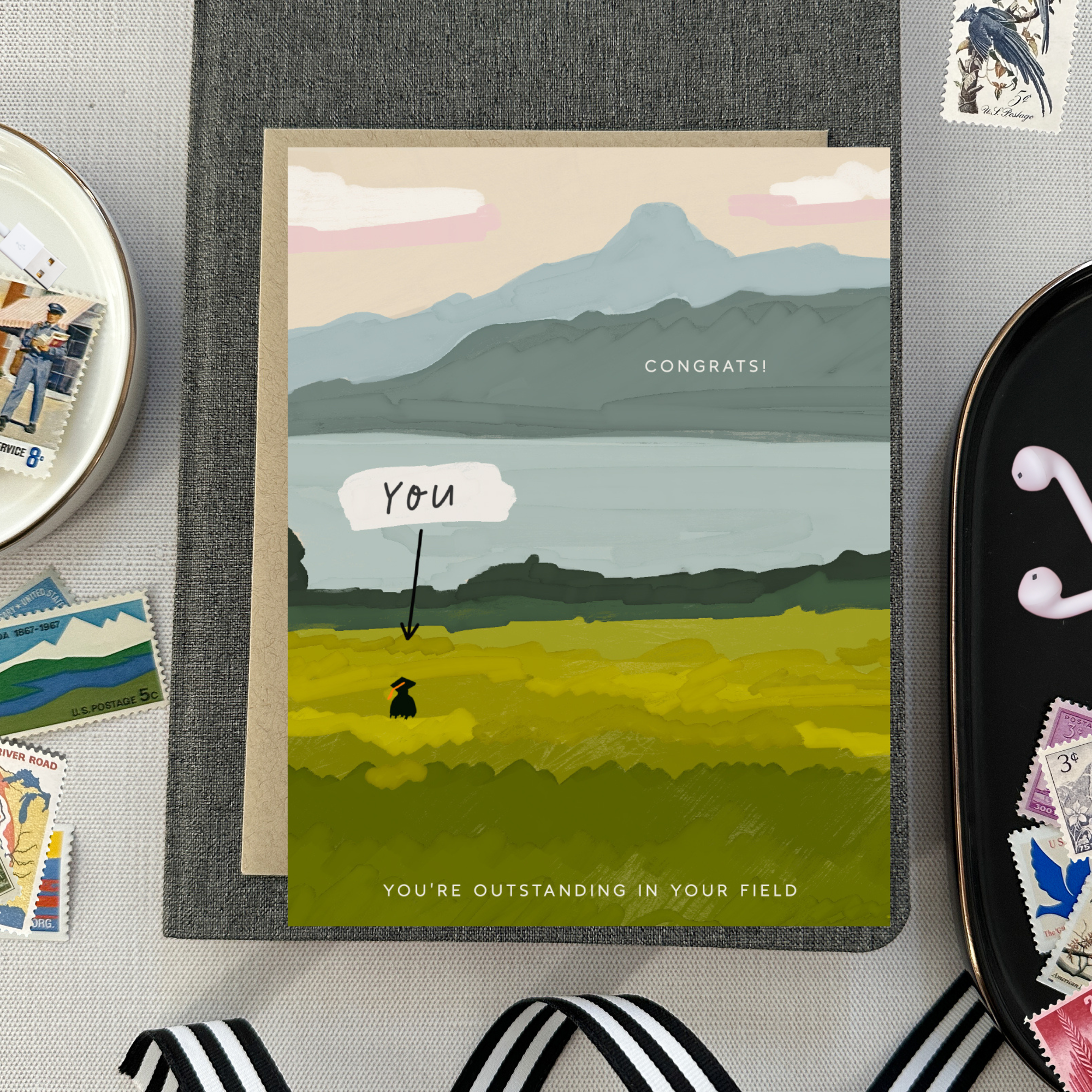 Graduation greeting card with person out standing in their field with a narrow pointing to them that says 'you'