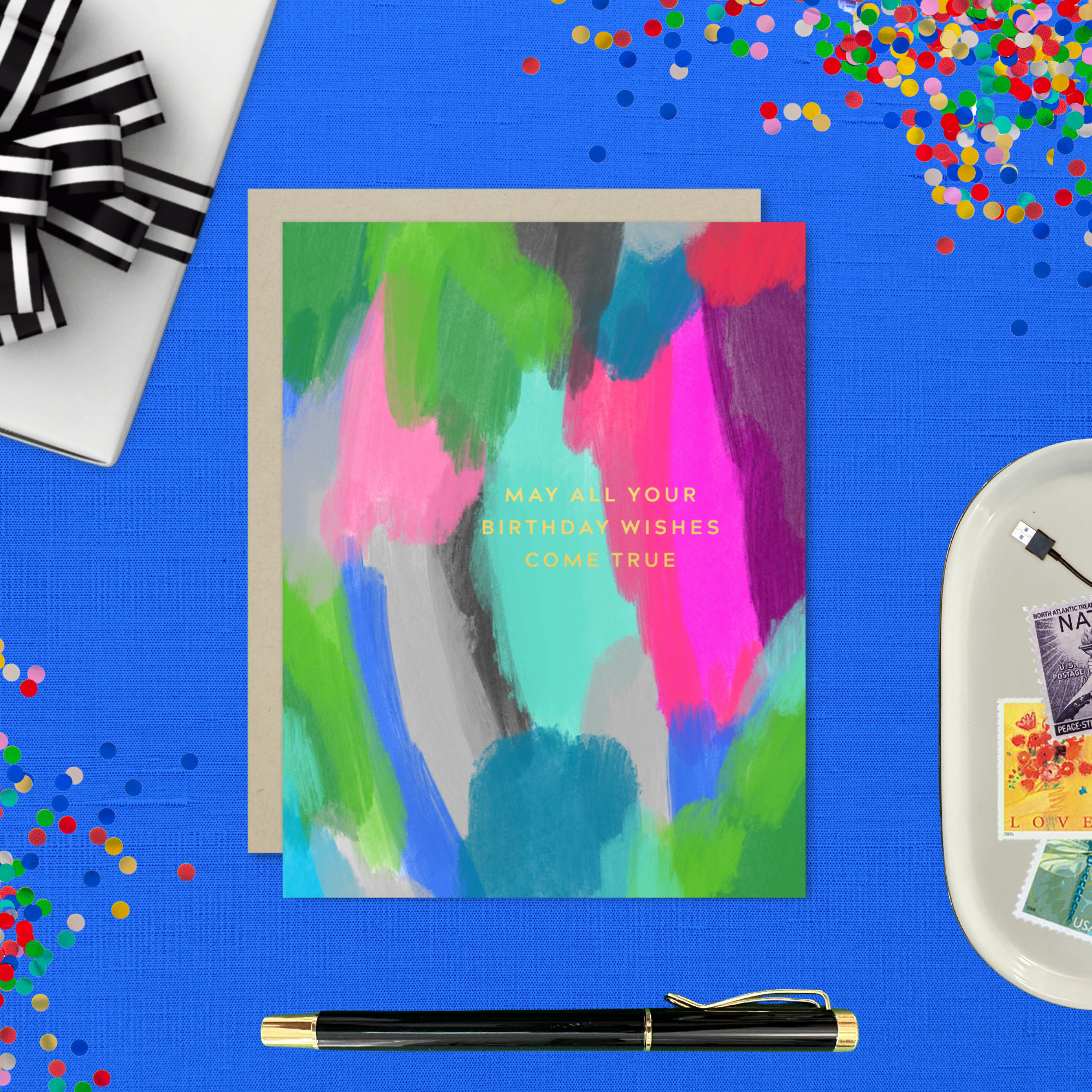A colorful birthday greeting card with a hand-painted abstract design and gold foil lettering that reads 'May All Your Birthday Wishes Come True'.