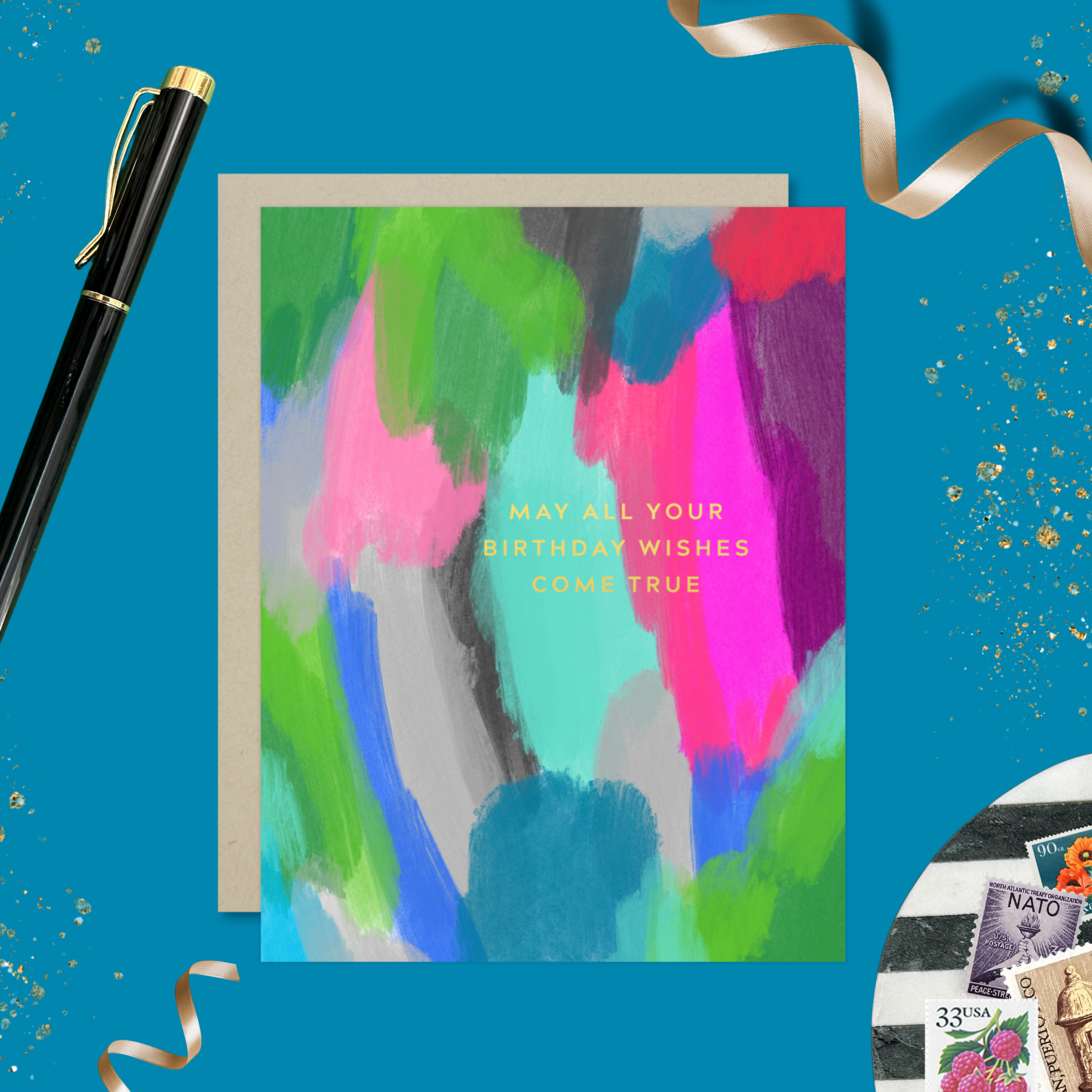 A colorful birthday greeting card with a hand-painted abstract design and gold foil lettering that reads 'May All Your Birthday Wishes Come True'.