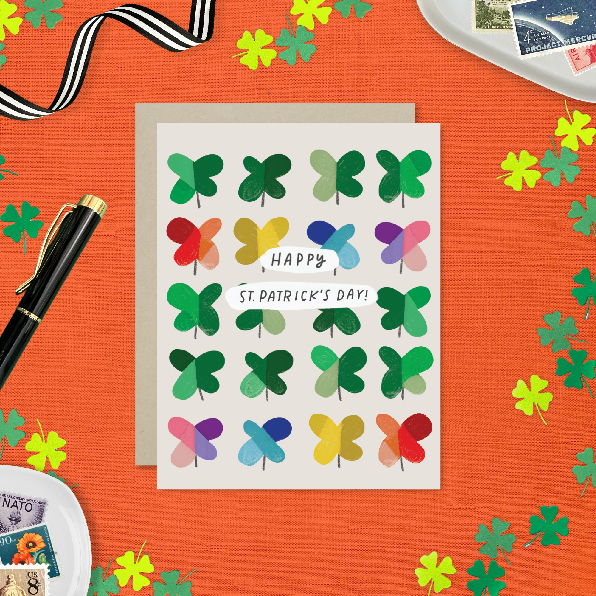 A St. Patrick's Day greeting card featuring a grid of colorful, painterly shamrocks with the message 'Happy St. patricks day
