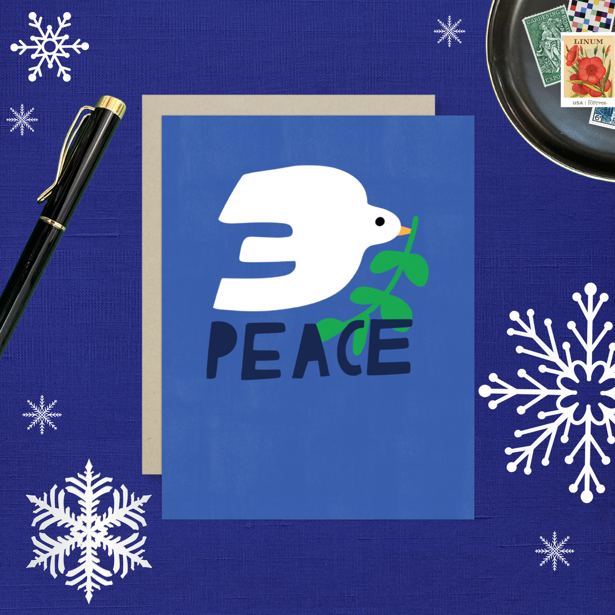 hand-painted holiday reeting card with a blue background featuring a white bird and the word 'PEACE' in capital letters.
