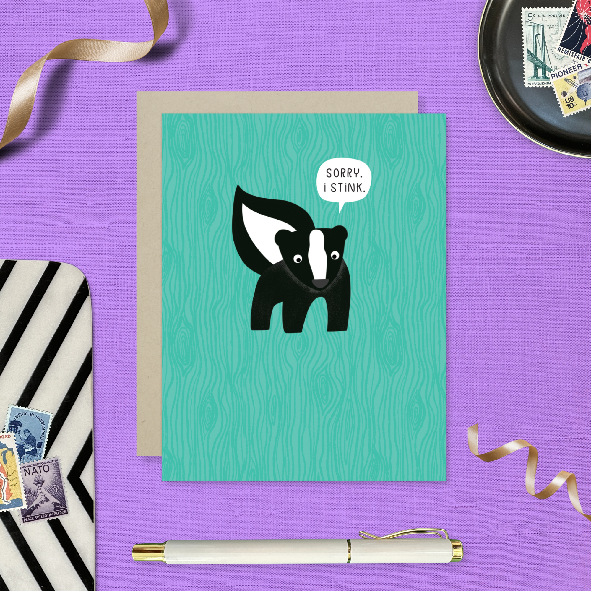 A sorry greeting card with an illustration of a skunk and the text 'Sorry I Stink' on a teal background.