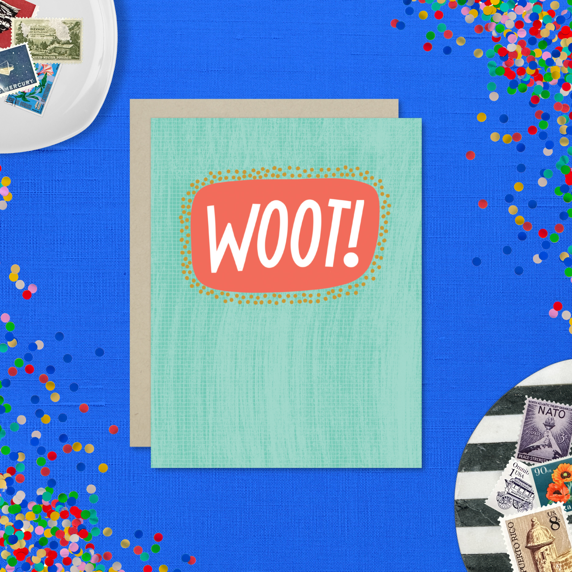 A congratulations greeting card with a hand-lettered word 'Woot!' written in bold, fun typography on a teal background with a textured appearance.