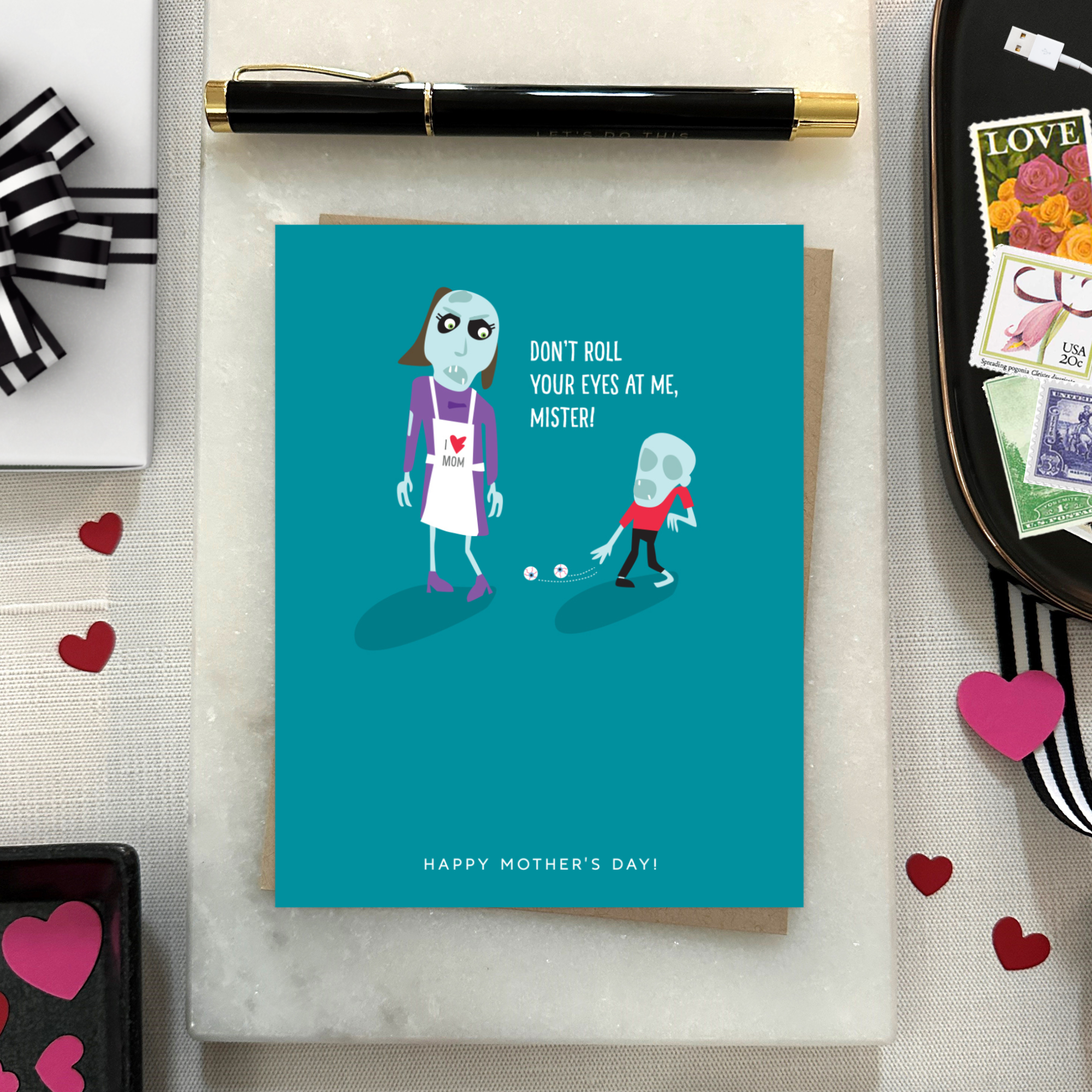 Mothers day greeting card with 2 zombies, one's eyes on the floor text 'don't roll your eyes at me, mister..happy mothers day'