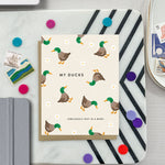 Funny greeting card with illustration of chaotic ducks and humorous text about letting go of perfection