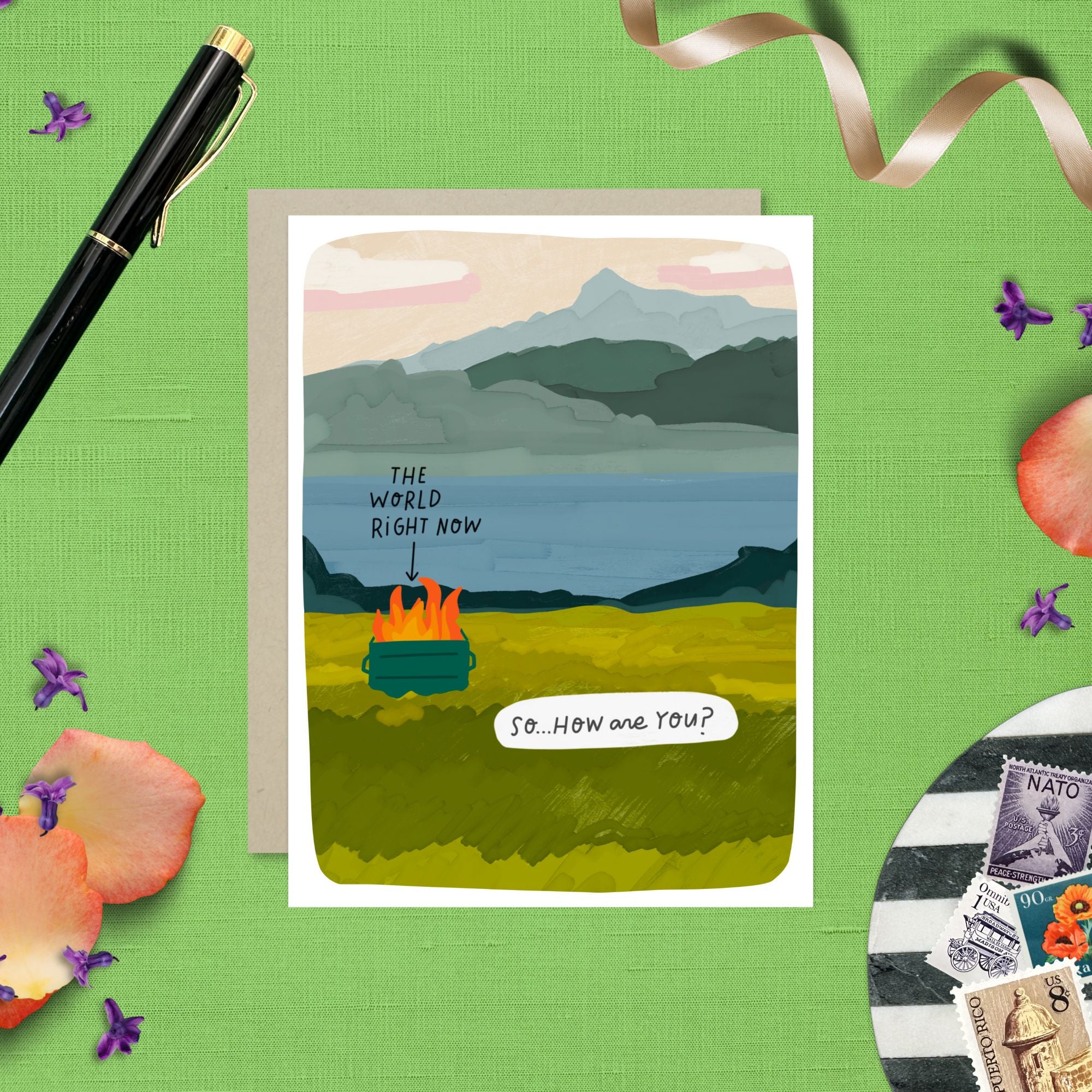 Greeting card with illustrated scenic landscape and a dumpster fire labeled “The World Right Now” with the caption “So… how are you?”