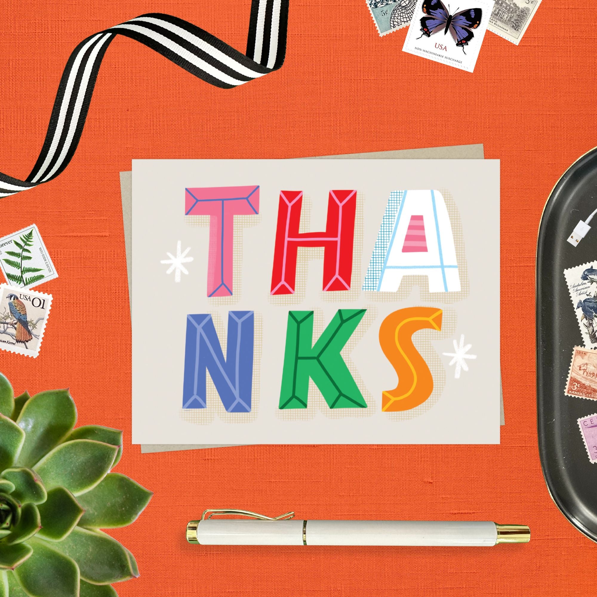 Thank you card featuring playful and colorful lettering with the word thanks. 
