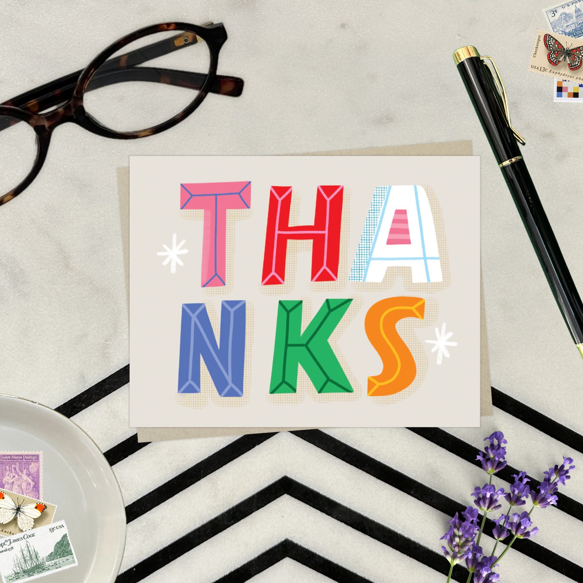 Thank you card featuring playful and colorful lettering with the word thanks. 