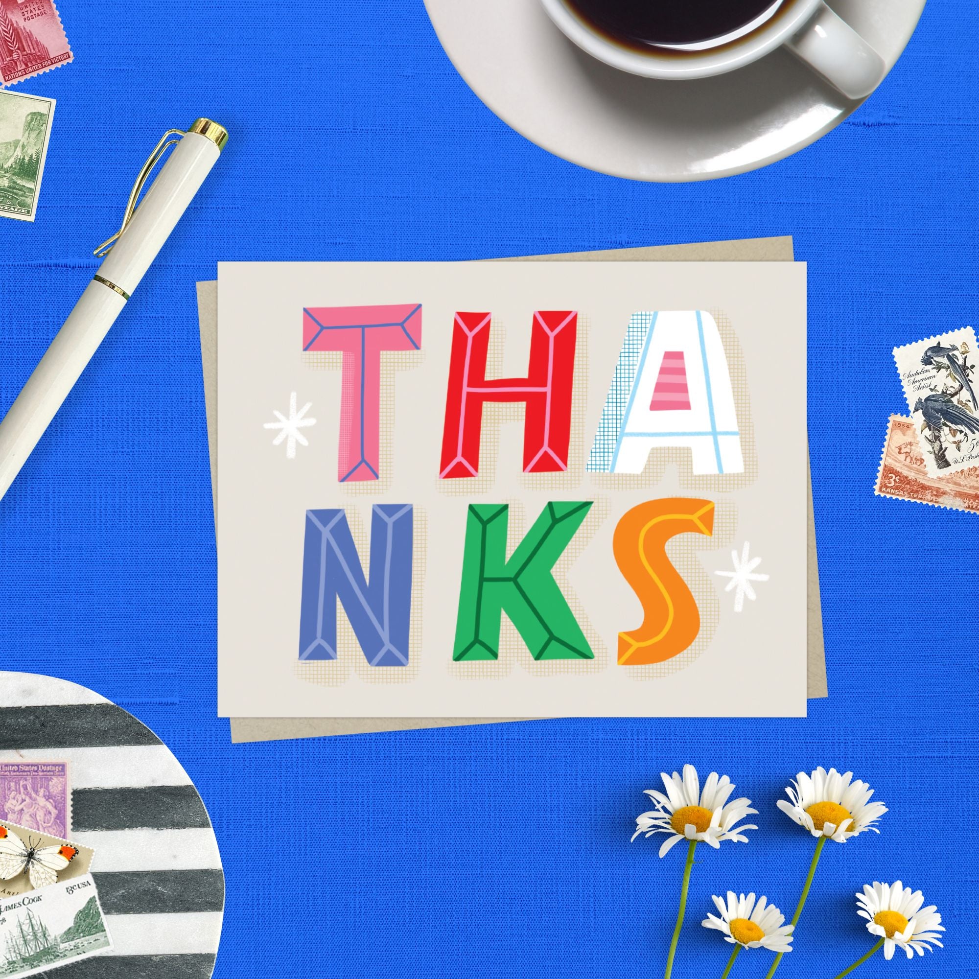Thank you card featuring playful and colorful lettering with the word thanks. 