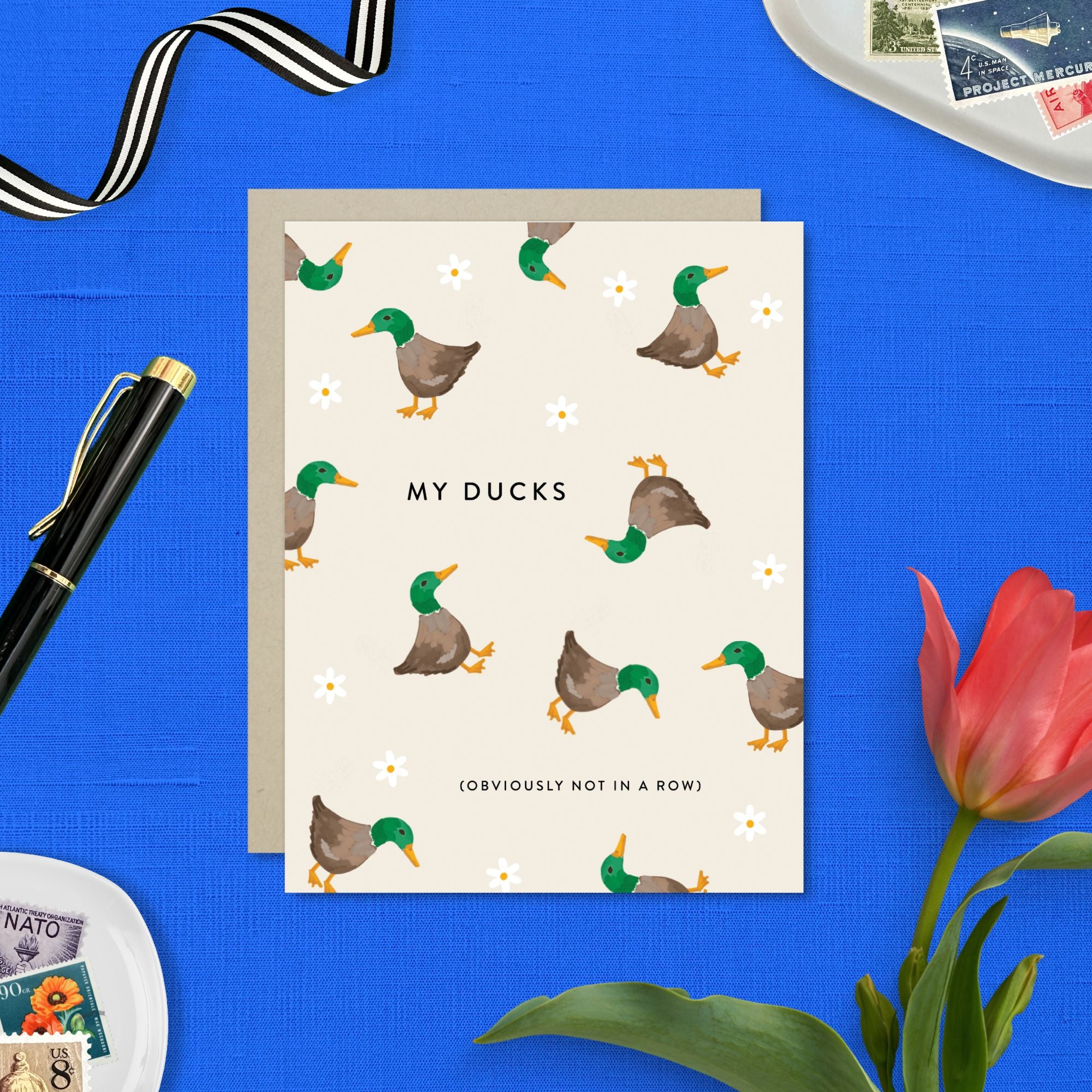 Funny greeting card with illustration of chaotic ducks and humorous text about letting go of perfection