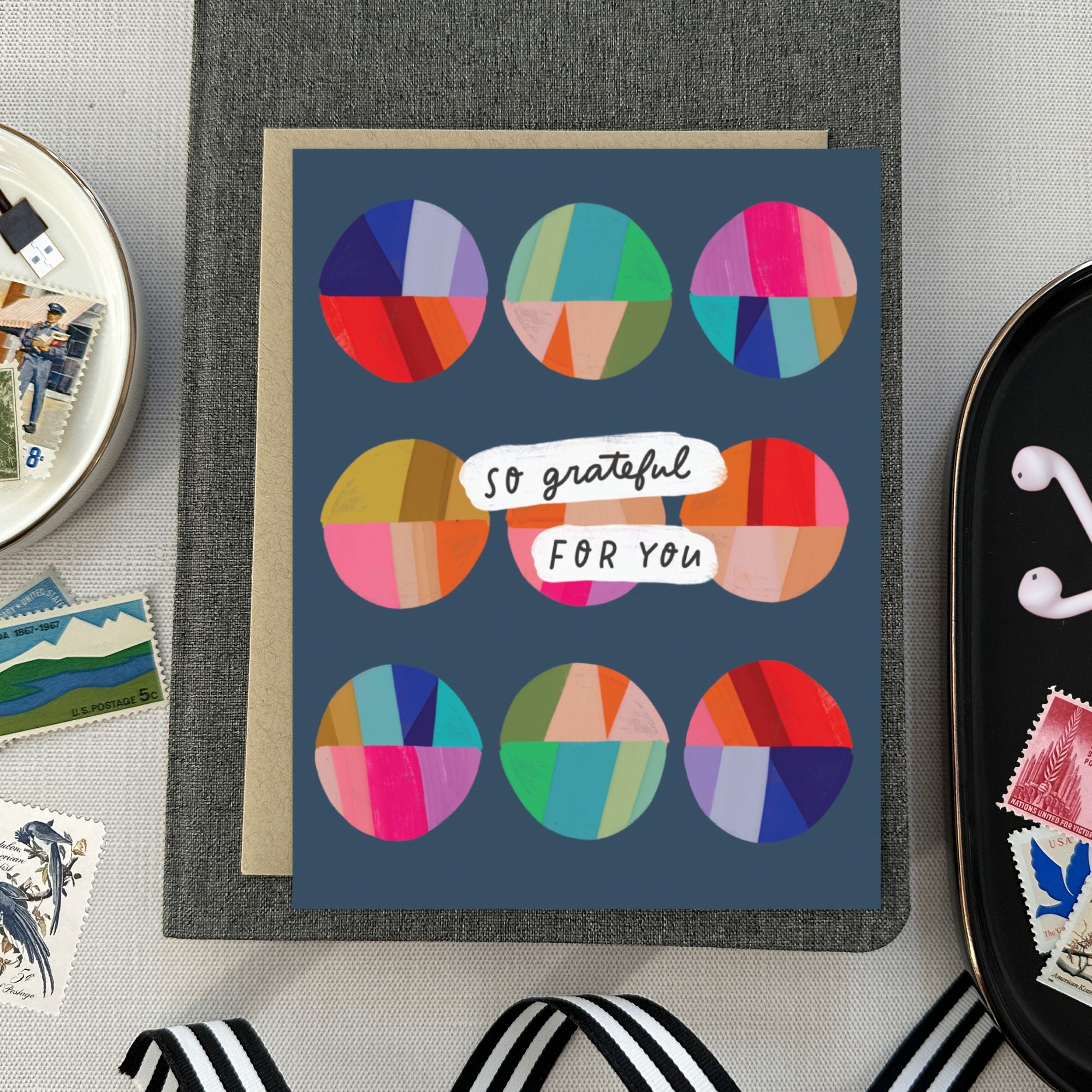 Thank you greeting card featuring a grid of colorful, hand-painted patchwork circles and the handwritten words So Grateful for You.