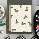 Funny greeting card with illustration of chaotic ducks and humorous text about letting go of perfection