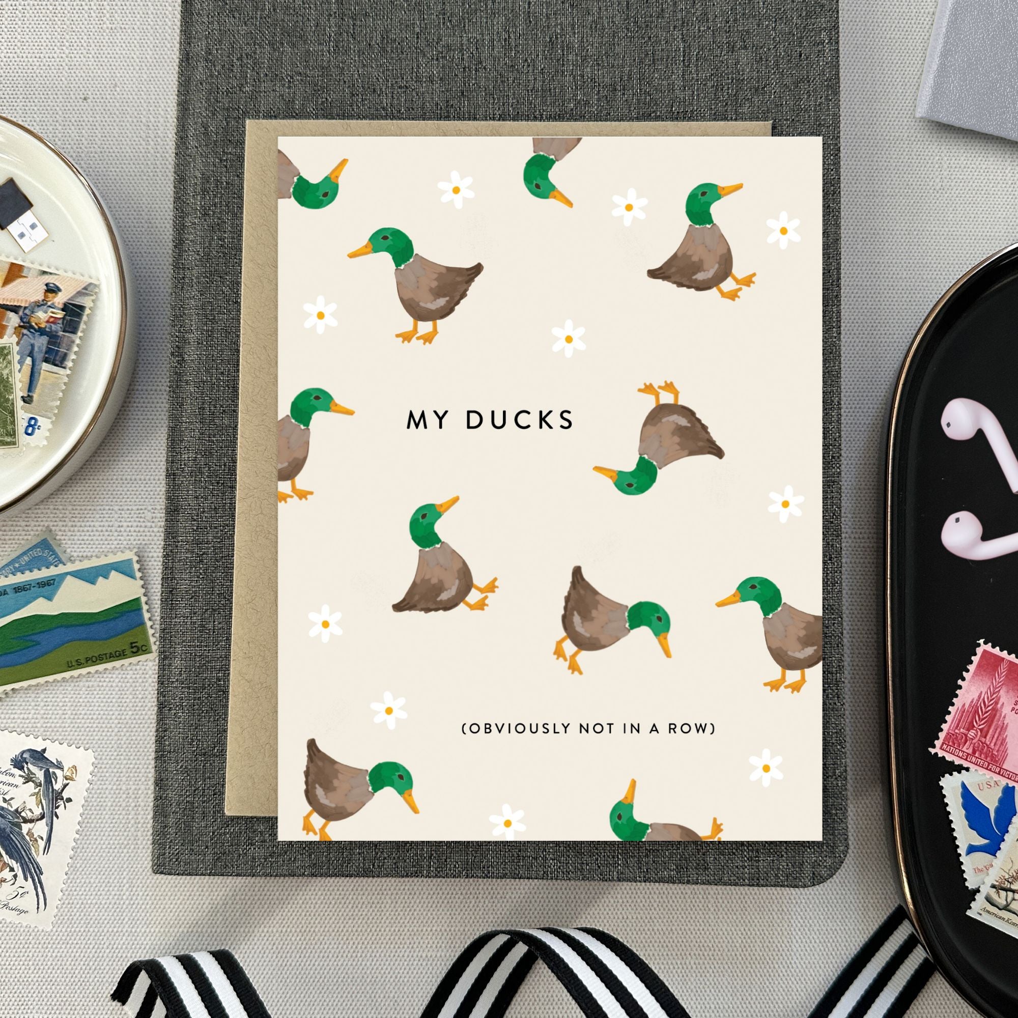 Funny greeting card with illustration of chaotic ducks and humorous text about letting go of perfection
