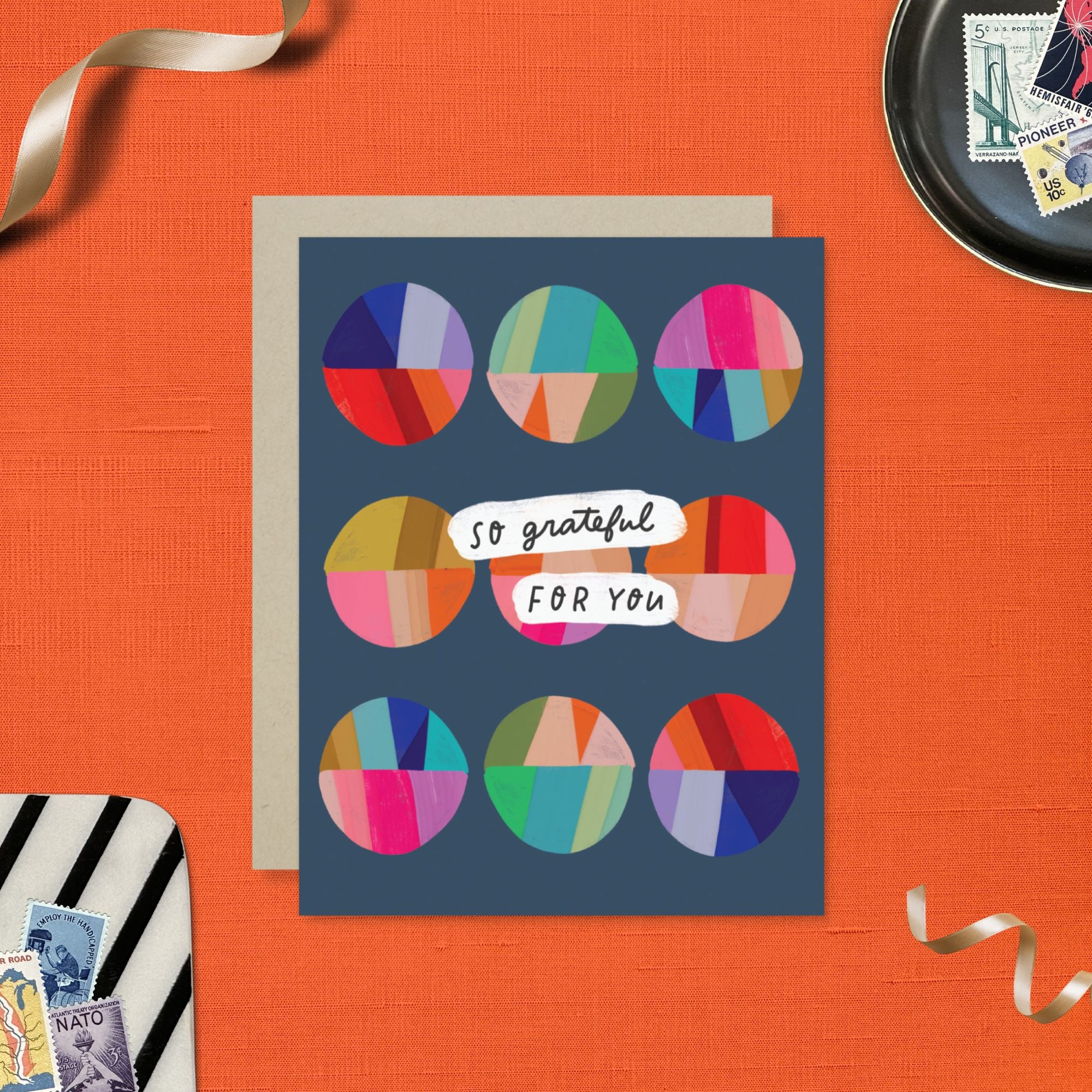 Thank you greeting card featuring a grid of colorful, hand-painted patchwork circles and the handwritten words So Grateful for You.