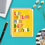 Greeting card with hand-lettered text “Less Hustling, More Dilly-Dallying” on bright yellow painterly background