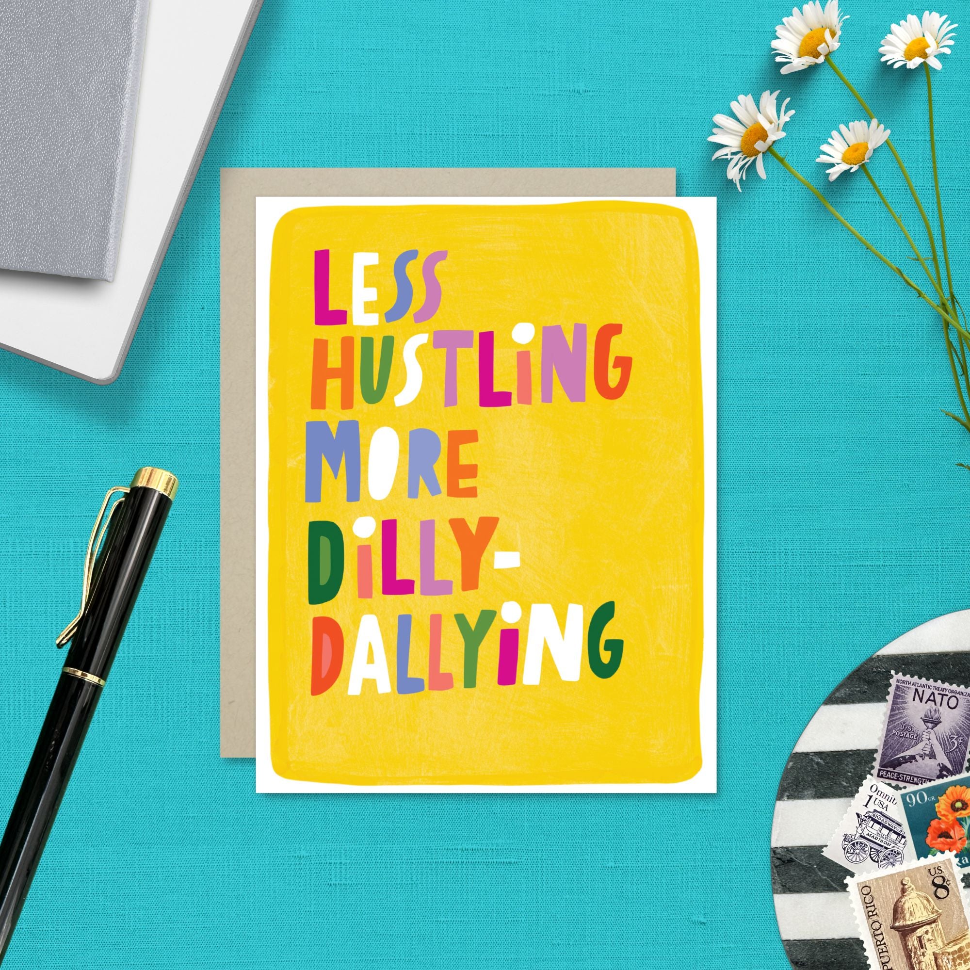 Greeting card with hand-lettered text “Less Hustling, More Dilly-Dallying” on bright yellow painterly background