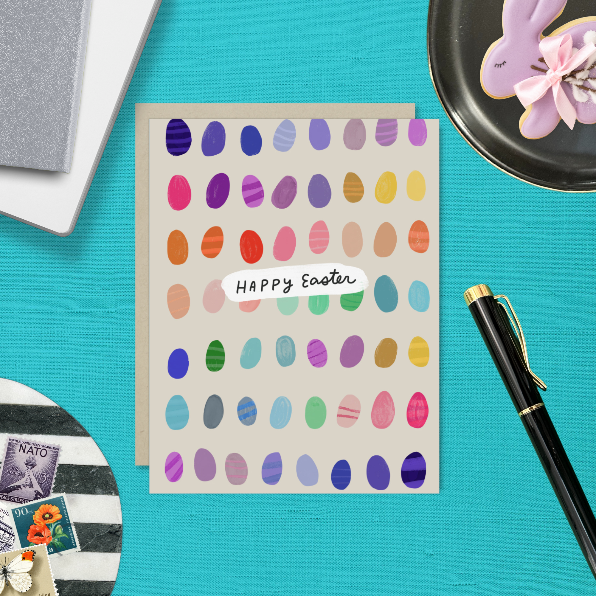 Easter greeting card with colorful eggs in the background with 'happy easter text'