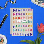 Easter greeting card with colorful eggs in the background with 'happy easter text'