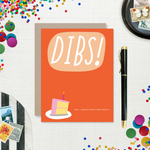 Card with 'DIBS! (Oh, I mean happy birthday! )' text and a cake illustration on an orange background.