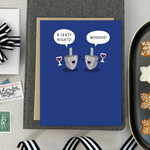 Hannukah greeting card with 2 dreidels drinking. One is saying '8 crazy nights' the other says 'woohoo!'