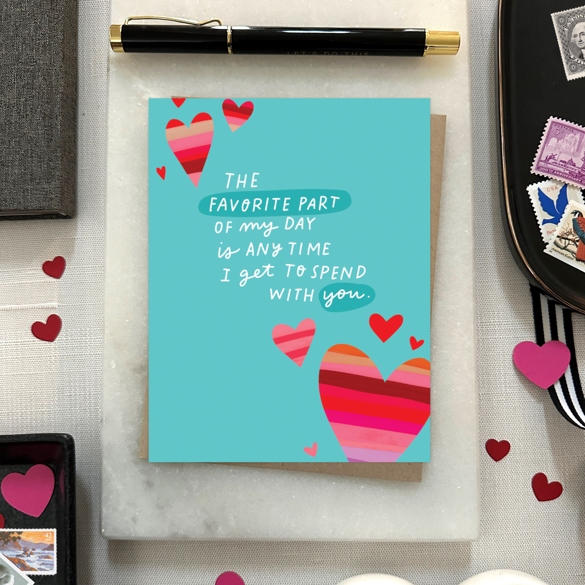 A wedding/anniversary greeting card with hand-lettered text expressing love, surrounded by heart designs.